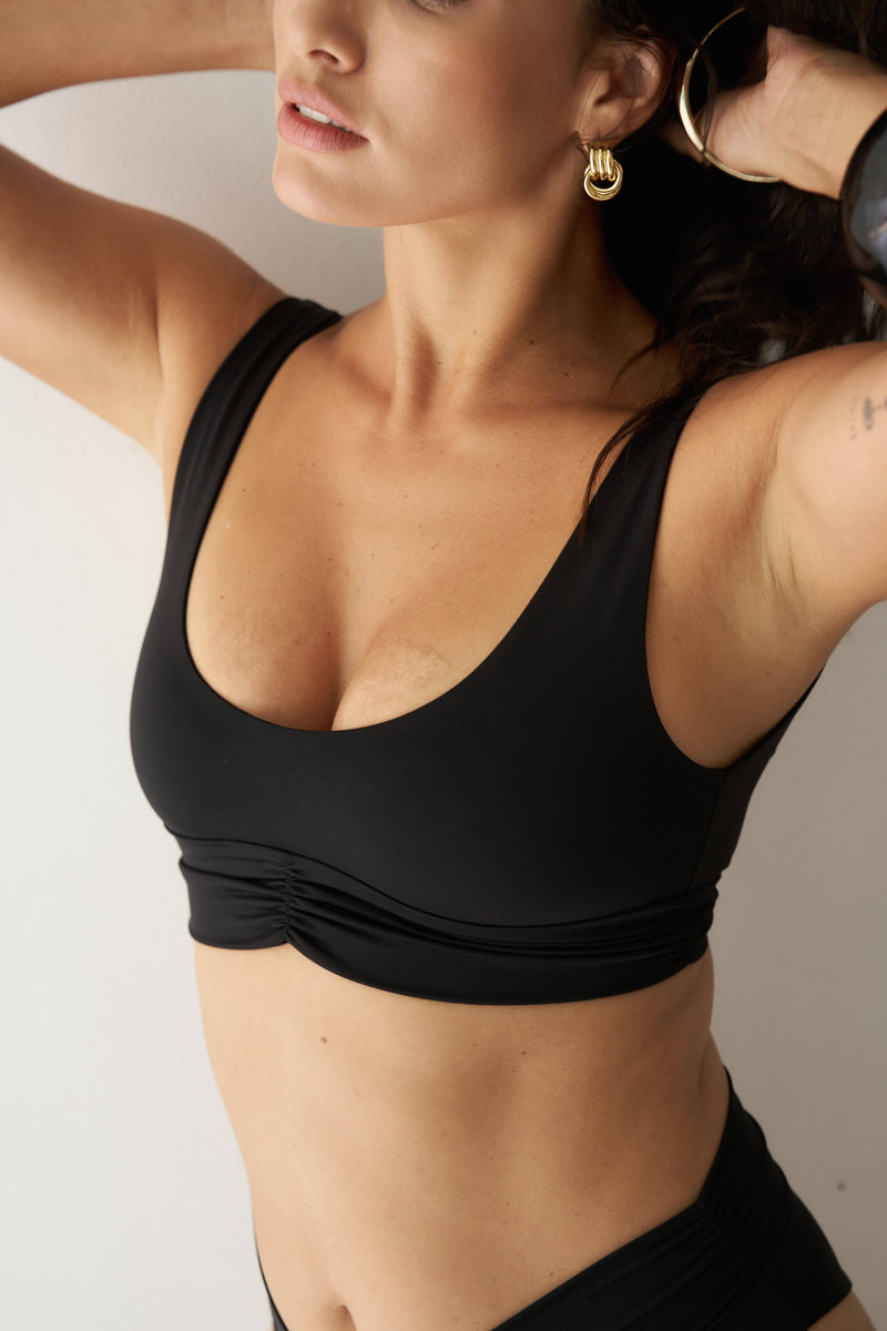 Black Pico Top from RIOT SWIM, a stylish sleeveless top with a fitted design, perfect for casual or beachwear.