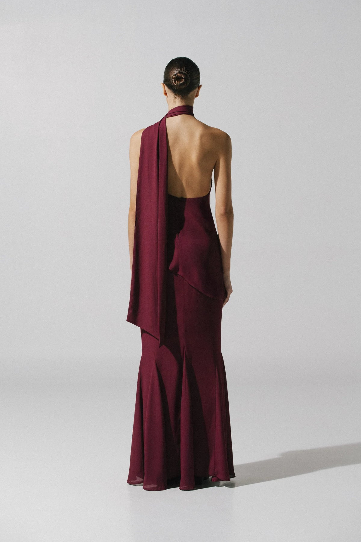 Burgundy Ari Skirt paired with pants, elegant style and Open back.