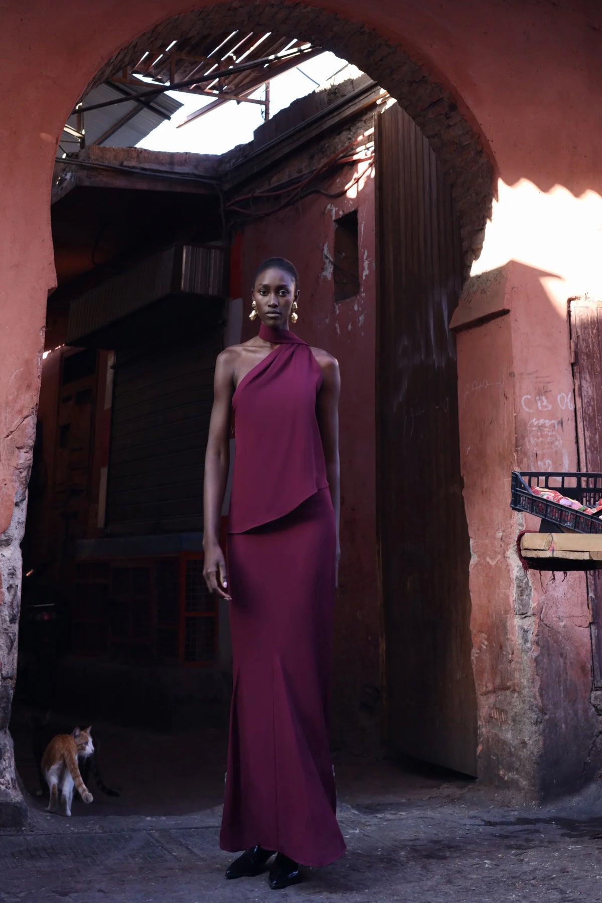 Ari Top by Baobab in urban outdoor setting, Scarf detail on shoulder and visible texture.