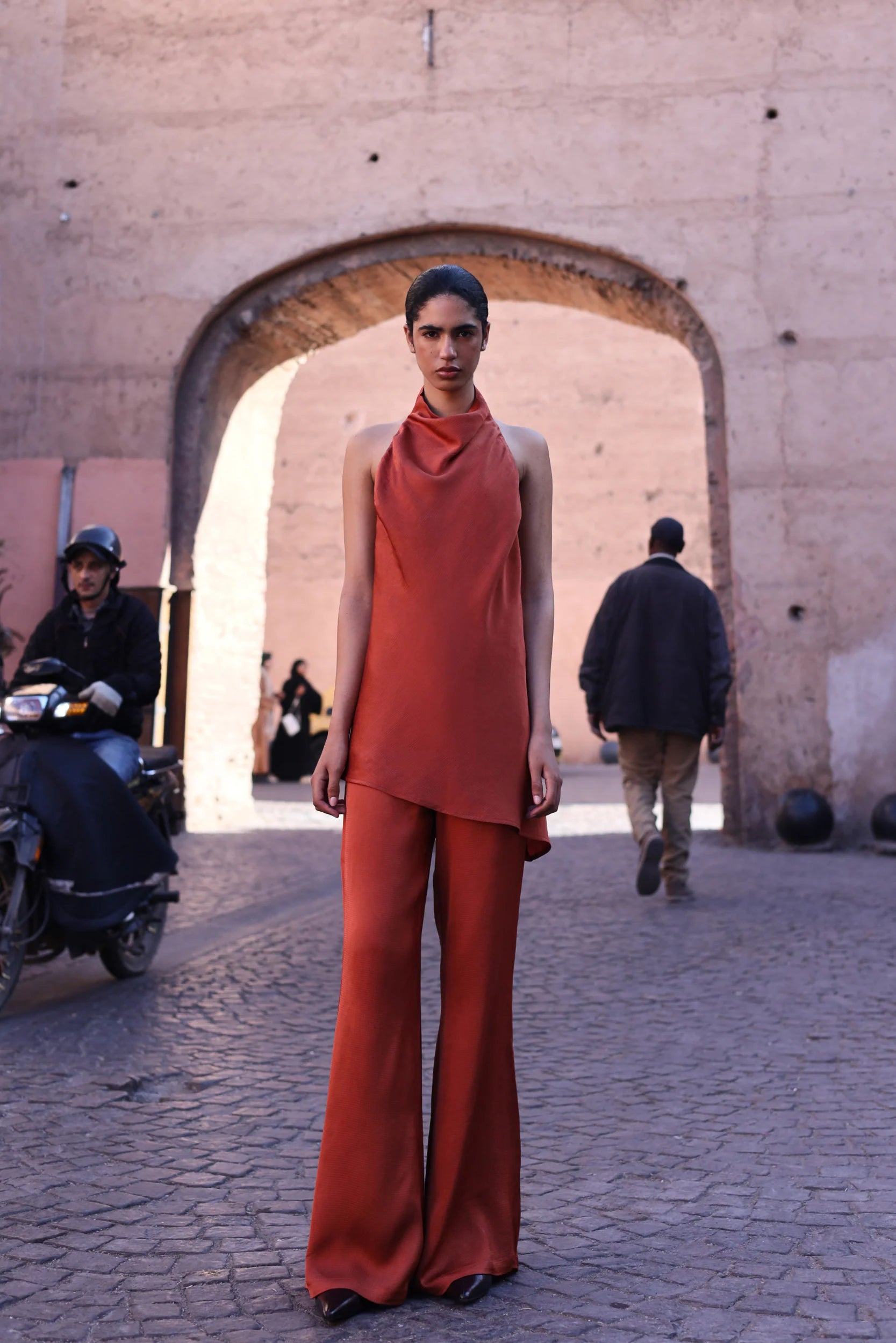 Numa Top by Baobab in terracotta color, Halter Neckline with Asymmetrical hem, urban look.