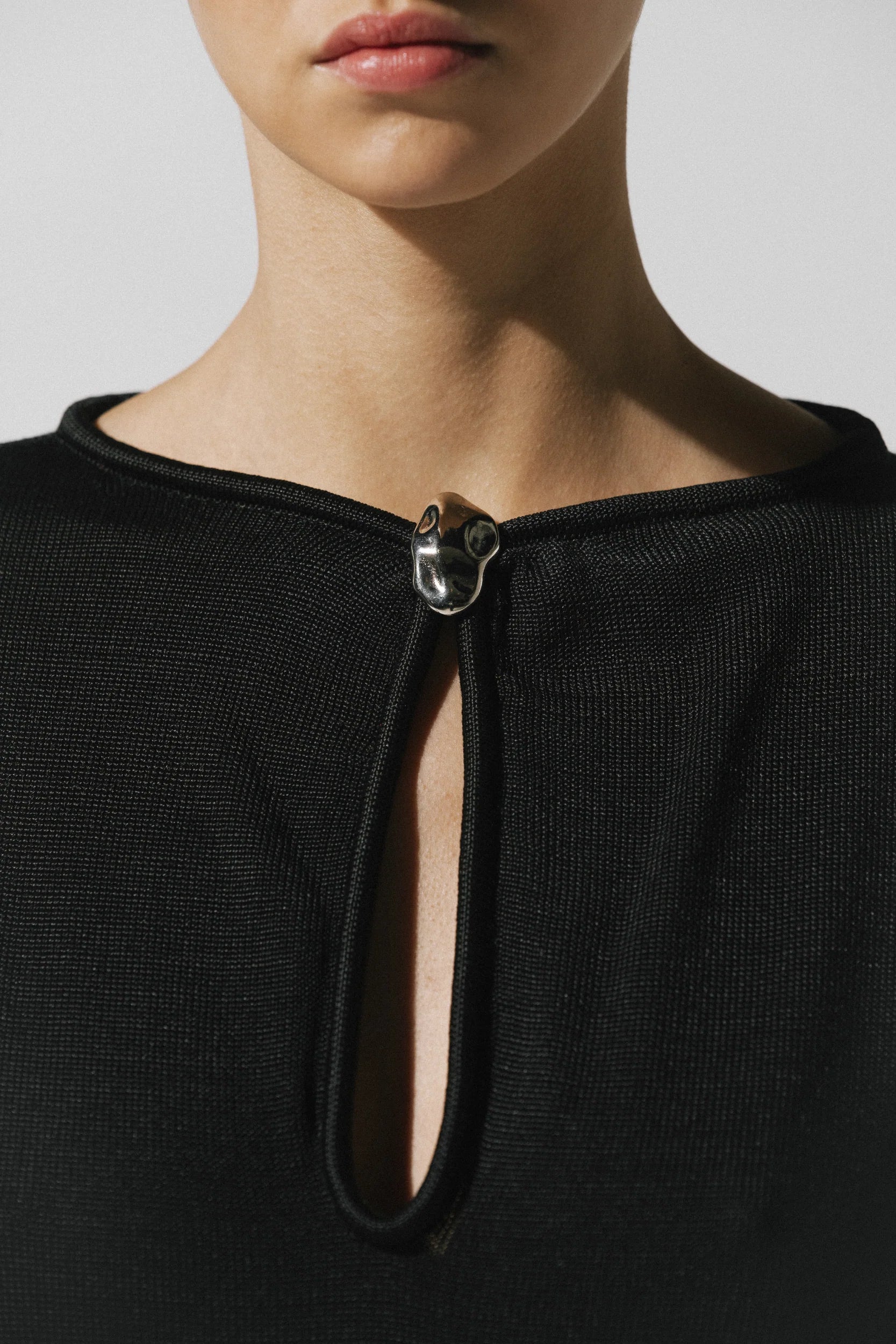 Black Ramila Dress, back view with fitted silhouette and Unlined design.