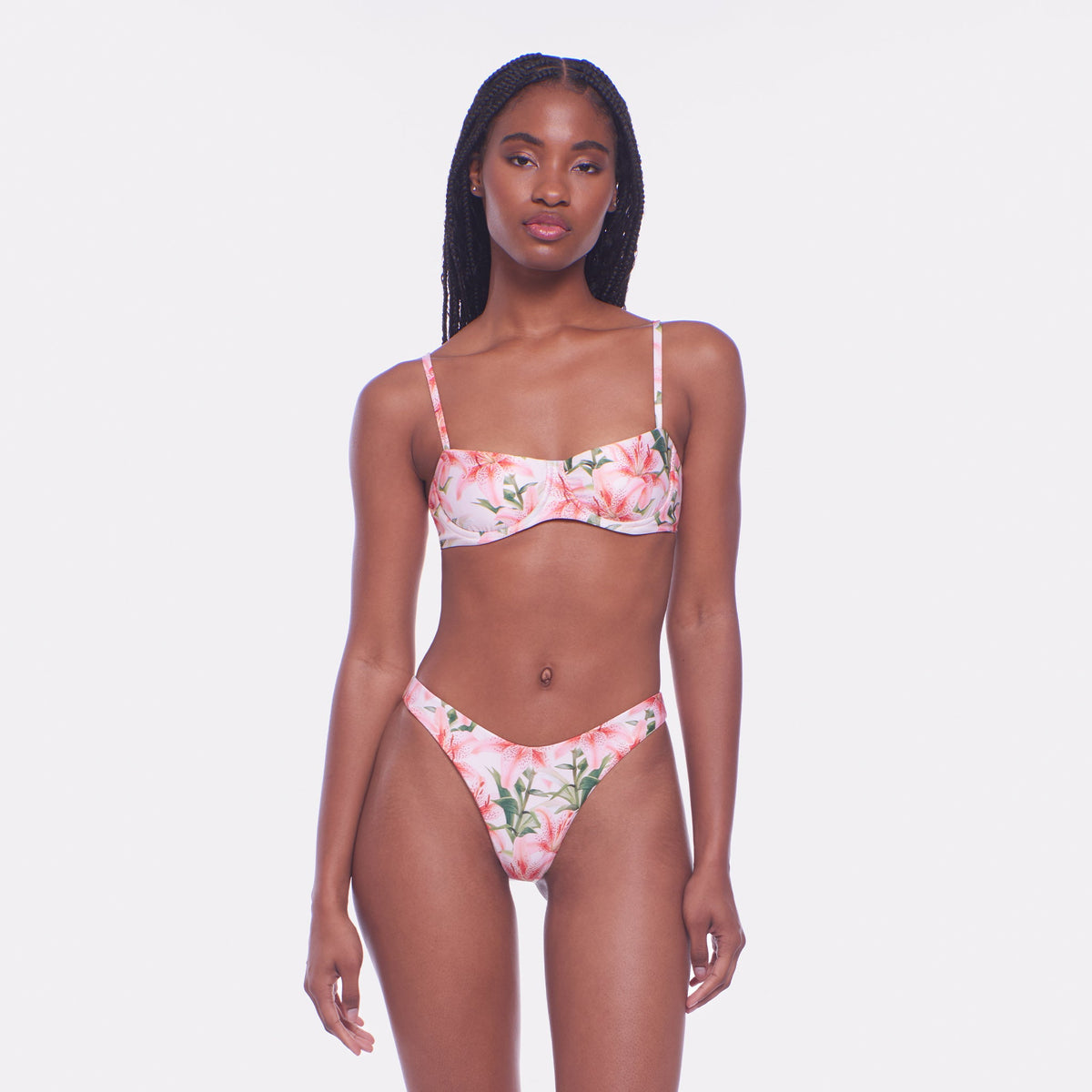 Woman wearing a floral bikini set on a white background