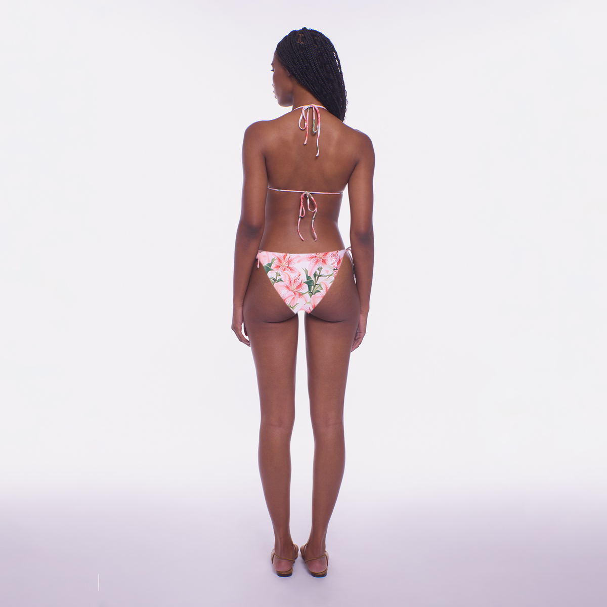 Person wearing a floral bikini on a white background