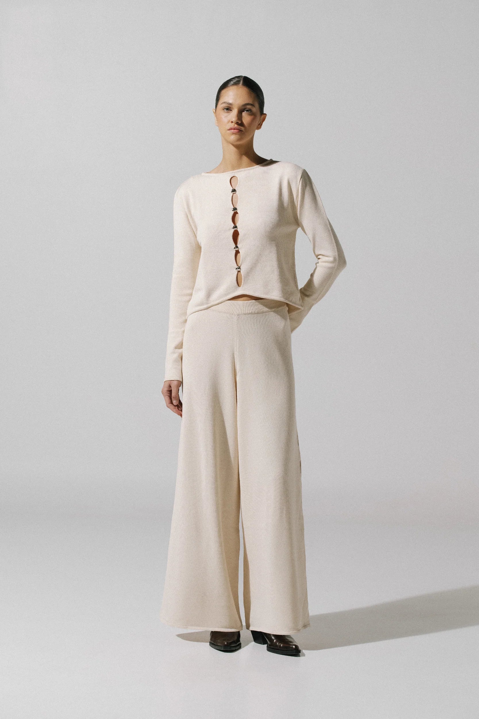 Kyoto Pants by Baobab in white cream color, Elastic waistband with Front cutouts and Embellished hardware.
