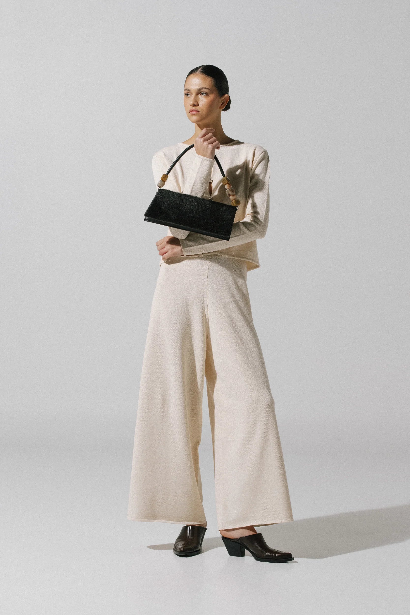 White cream Kyoto Pants, side view with Ribbed texture and relaxed cut.