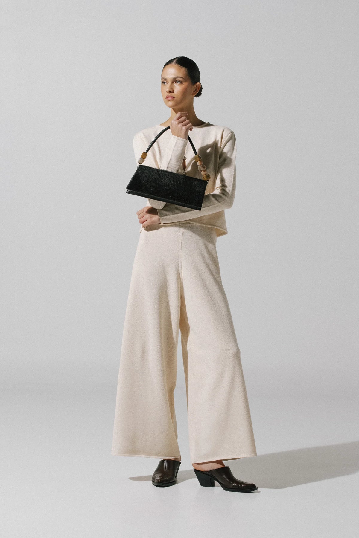 White cream Kyoto Pants, side view with Ribbed texture and relaxed cut.