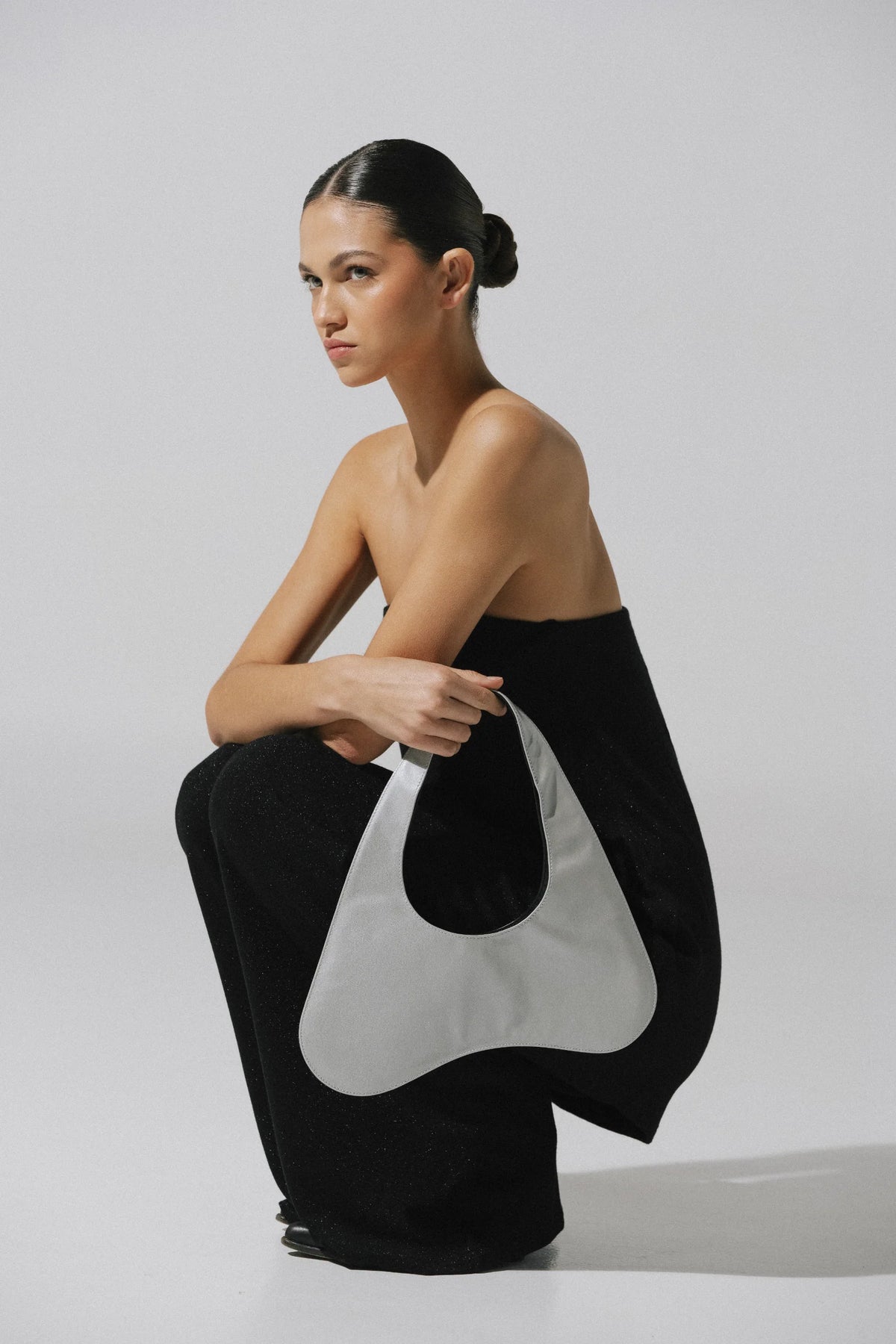 Black Suzu Pants with Flared fall, Glossy fabric and Elastic waistband.