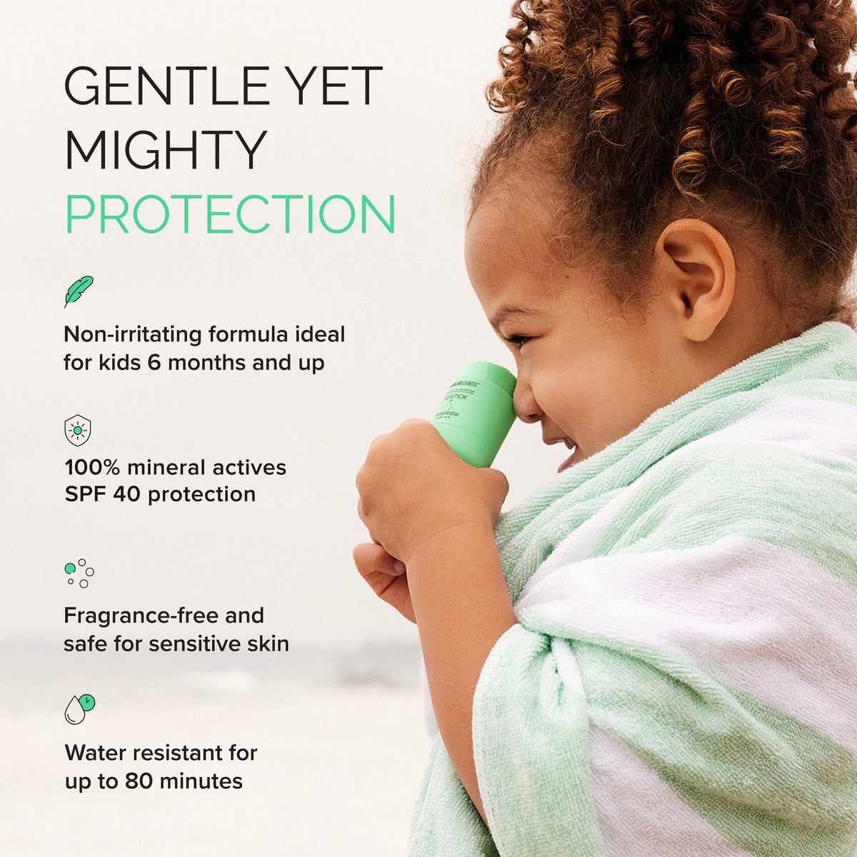Child holding a green sunscreen product with text about its features