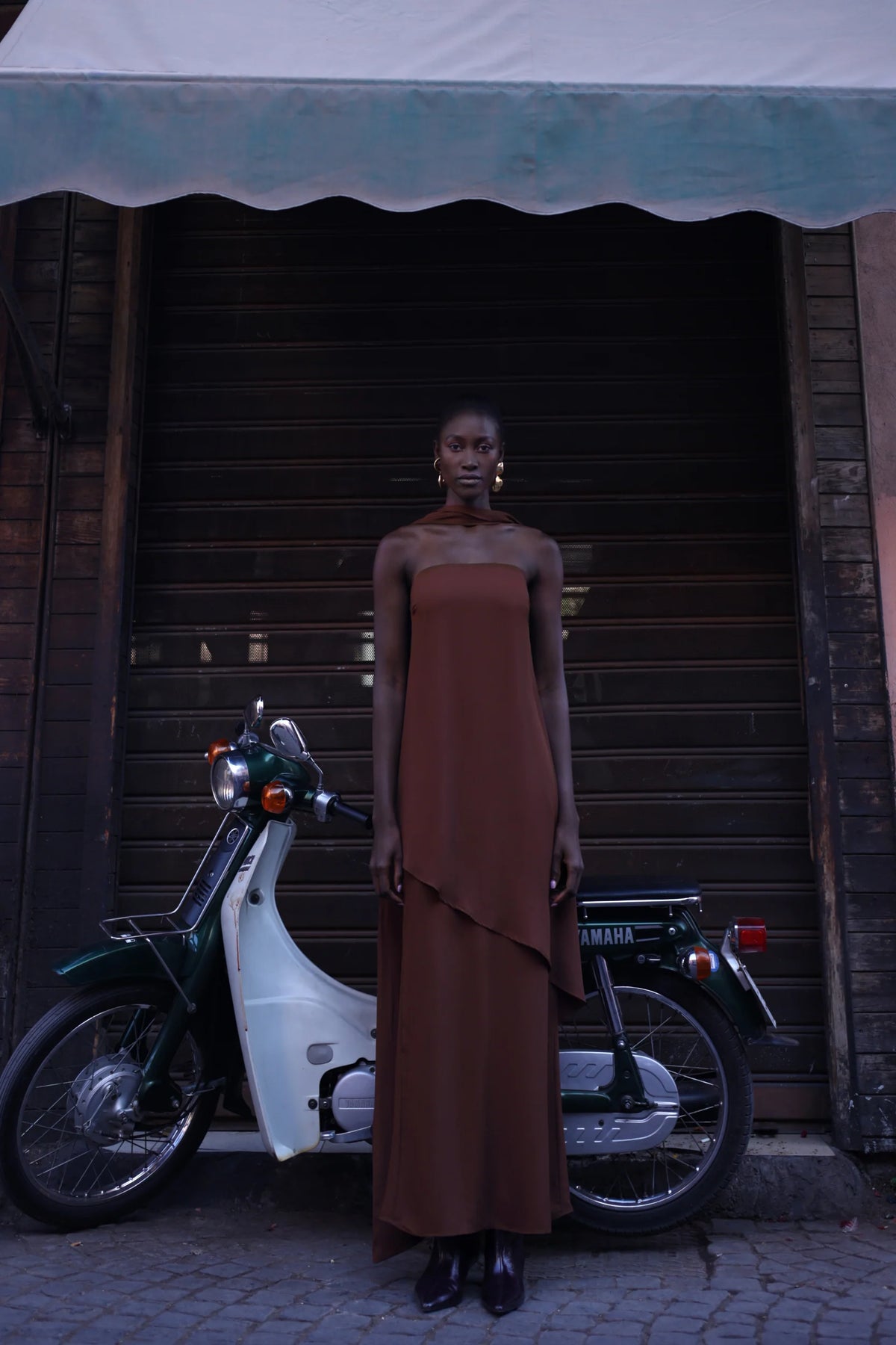 El Maxi Dress in chocolate color with Open back, Scarf detail and elegant silhouette.