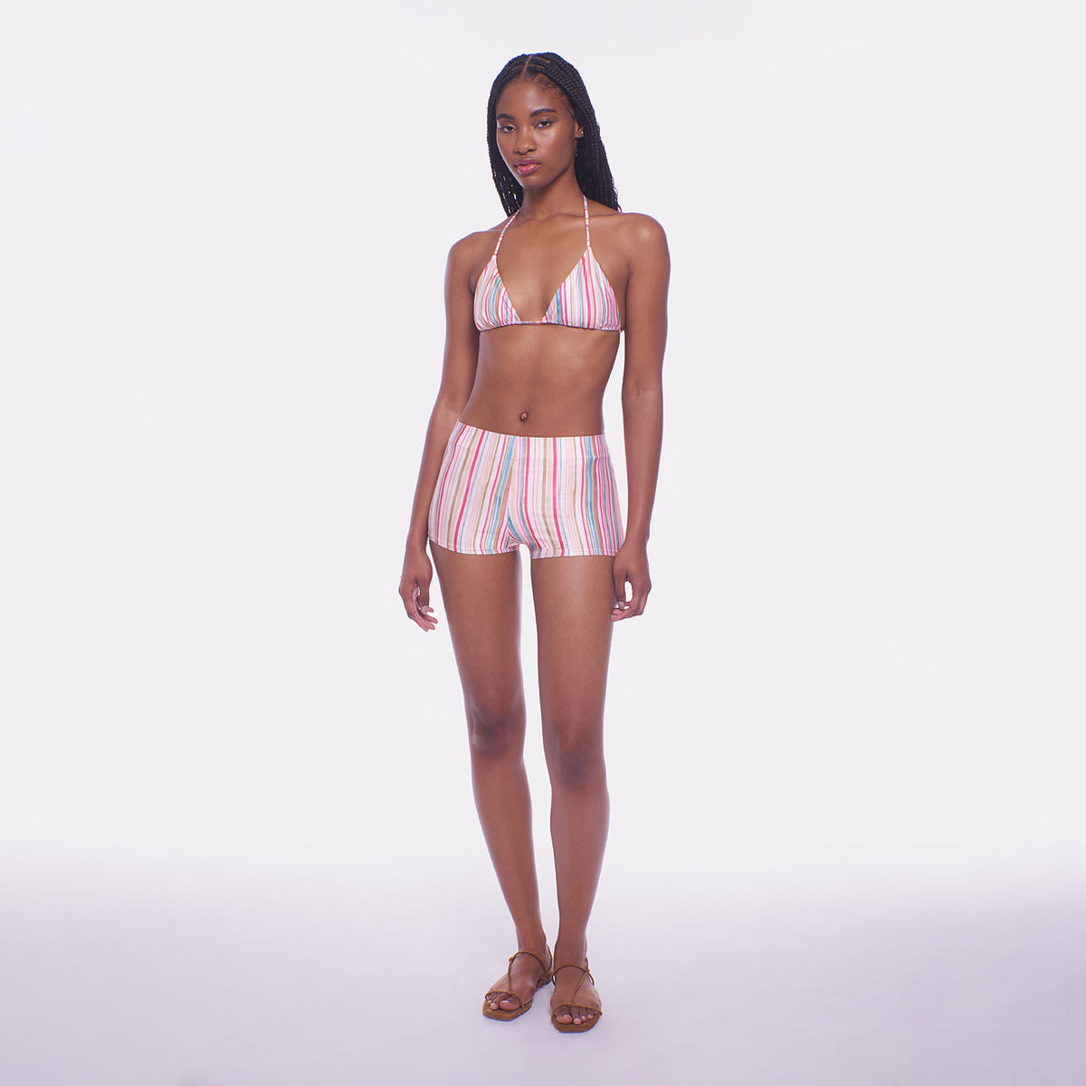 Woman wearing a striped bikini set on a white background