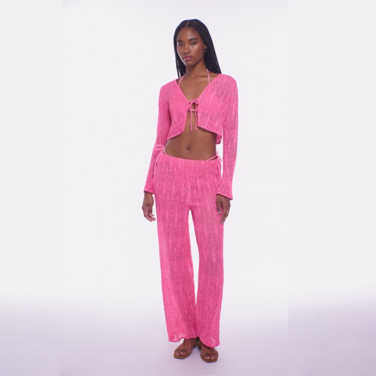 Woman wearing a bright pink outfit on a white background