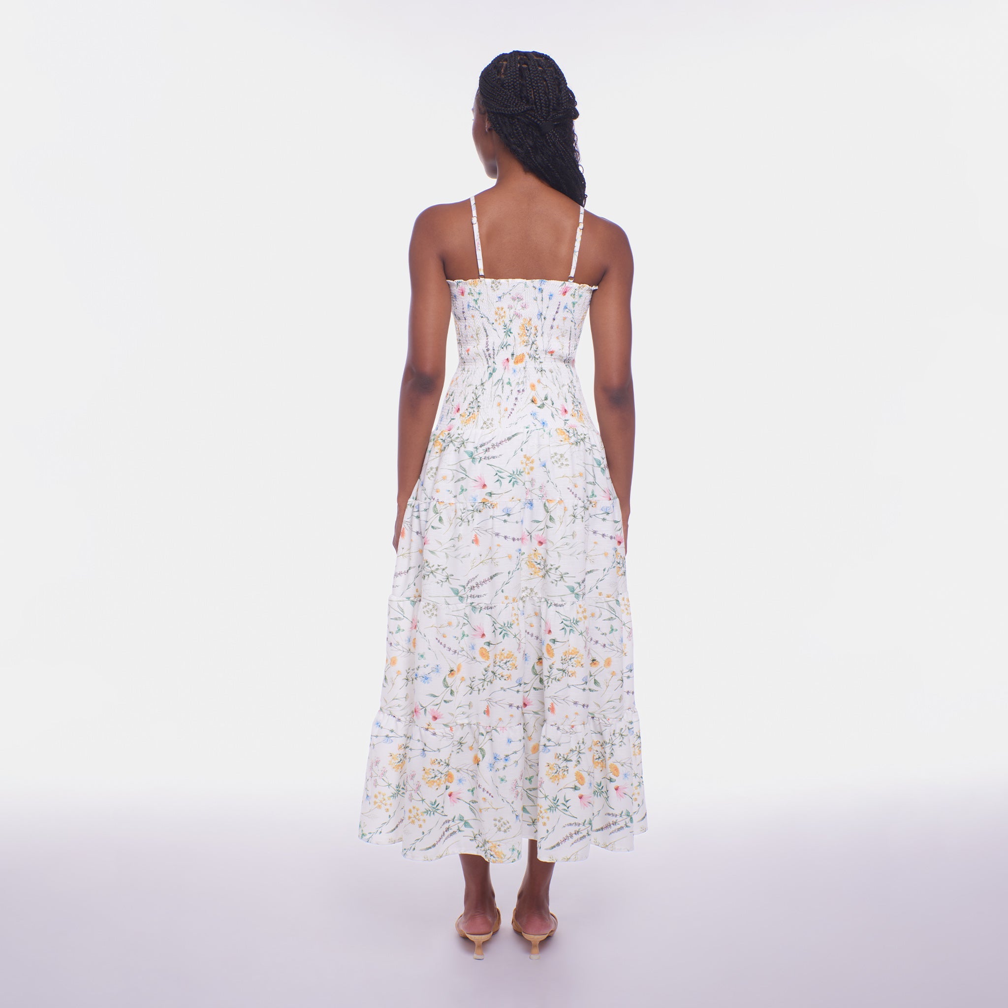 Woman wearing a floral dress on a white background