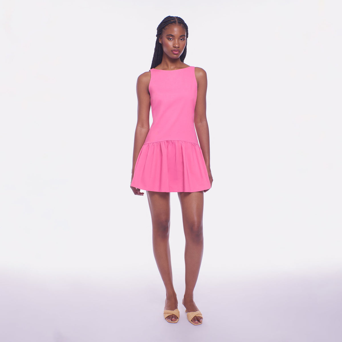 Woman wearing a pink dress on a white background
