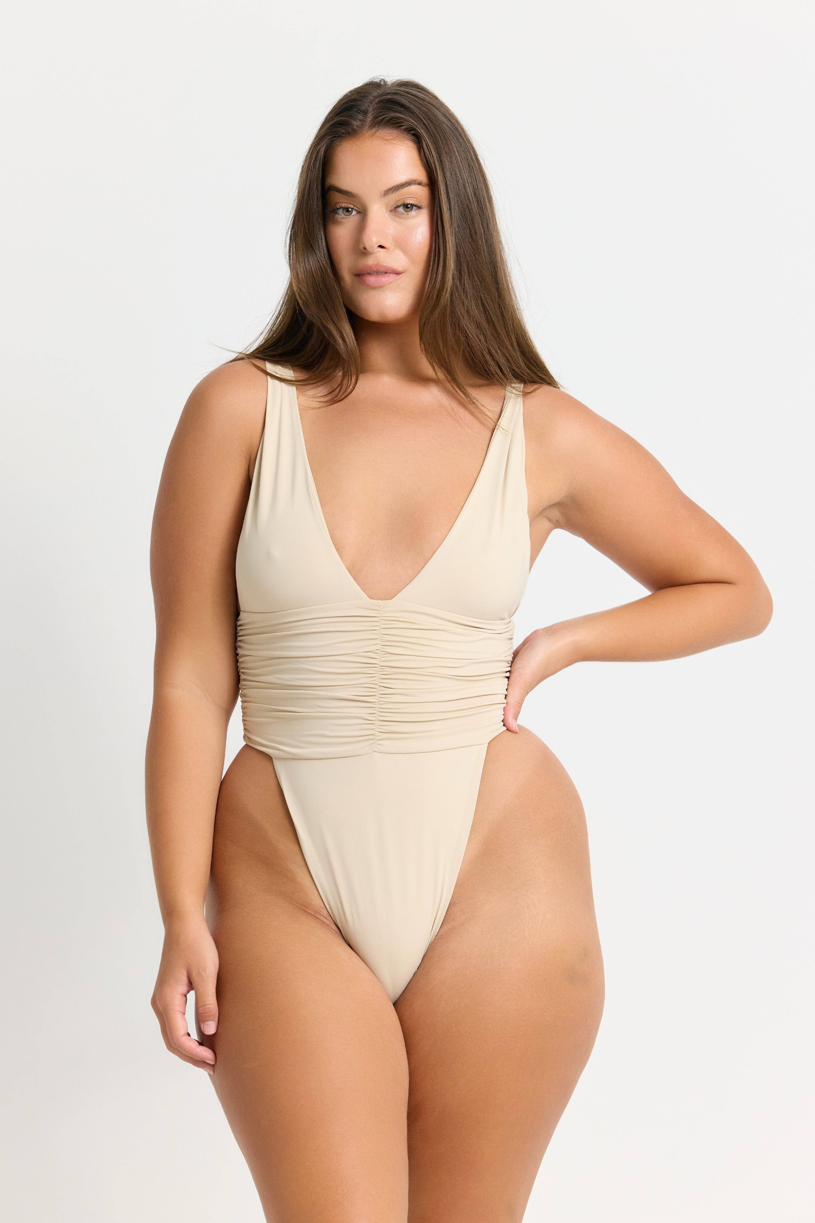 RIOT SWIM Echo One Piece Minimal swimsuit in coconut color, featuring a sleek design and minimal coverage, displayed on a model.
