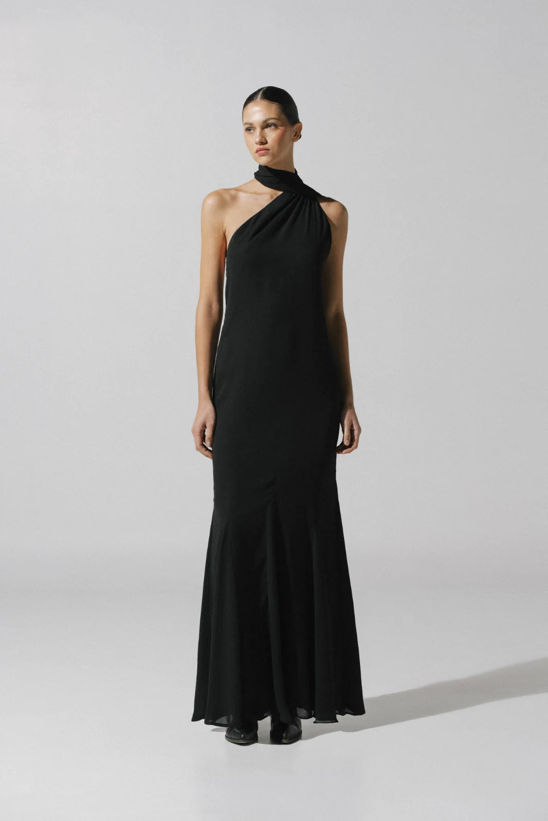 Black Ari Dress with Adjustable strap, fluid fabric and Godets in hemline.