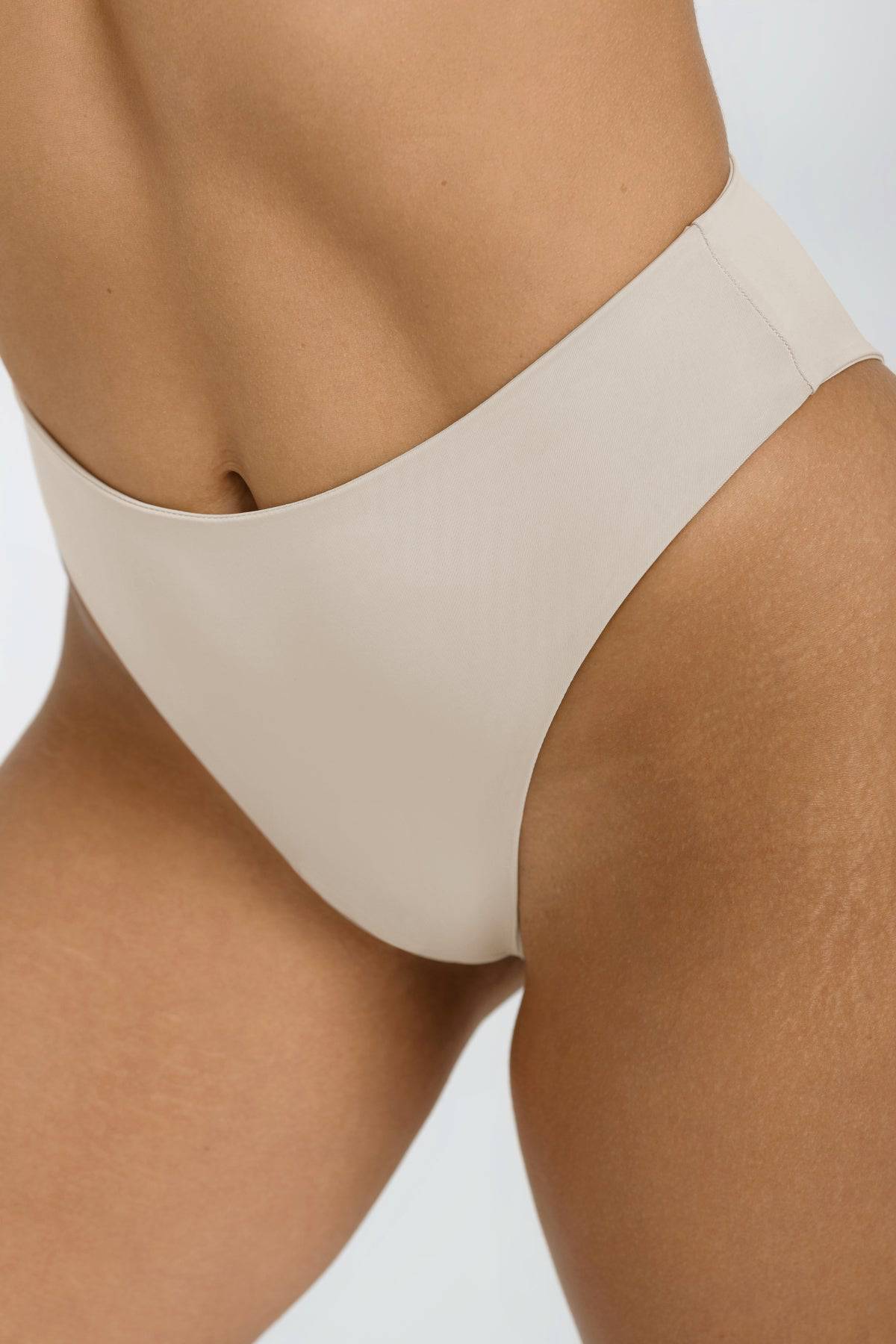 Beige Riot Swim Willow Bottom bikini bottom with a front view, showcasing a stylish and comfortable swimwear design.