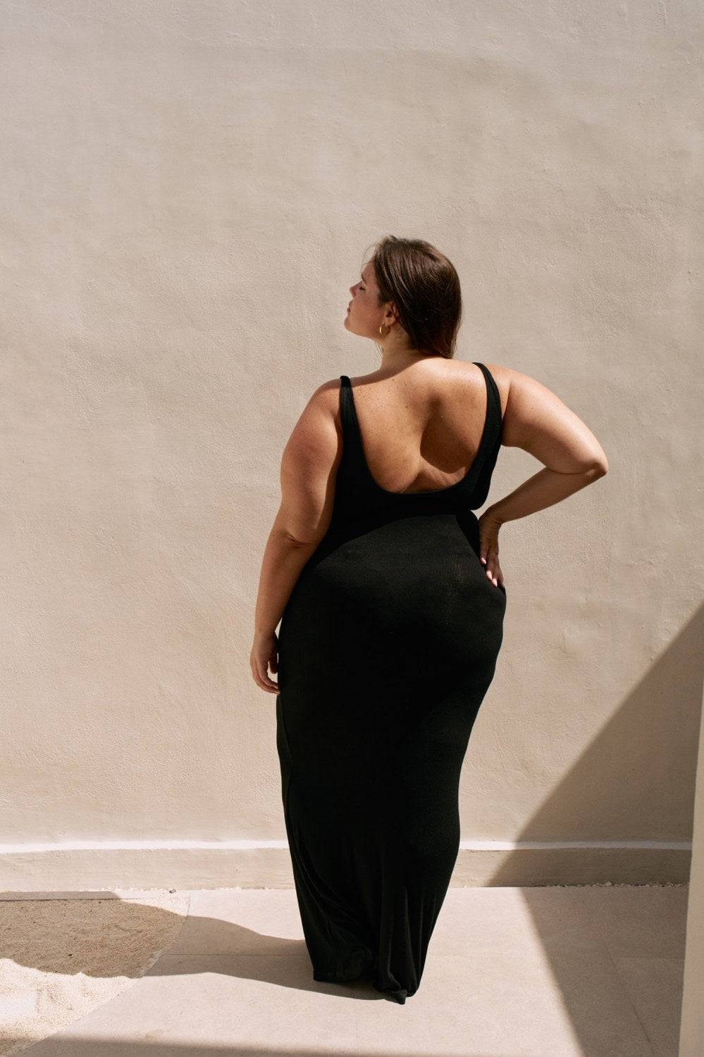 Black Reily Maxi Dress by Riot Lounge, flowing fabric and stylish design, shown on a model in a full-length shot.