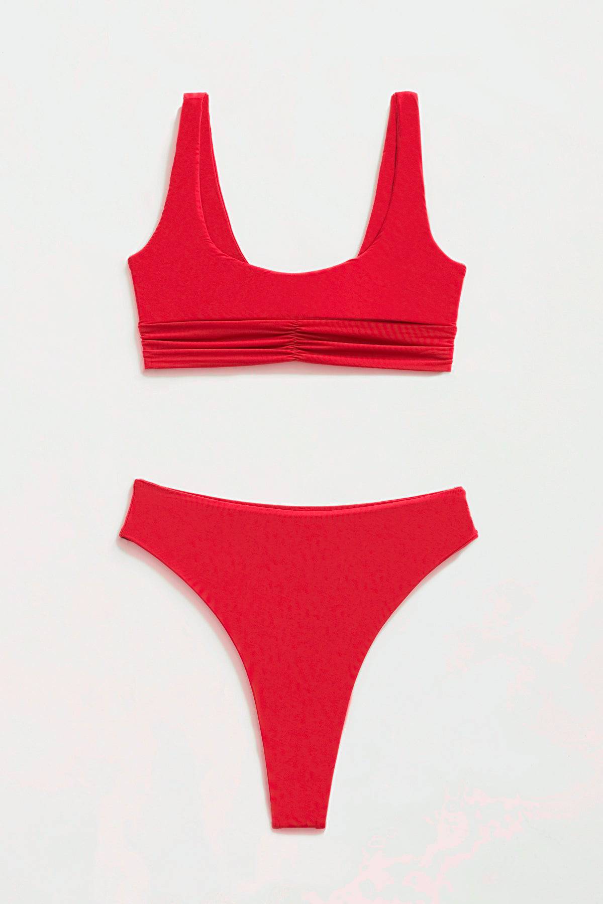Riot Swim Kai high waist fire red bikini bottom with a thong style, shown with matching top, vibrant swimwear for beach or pool.