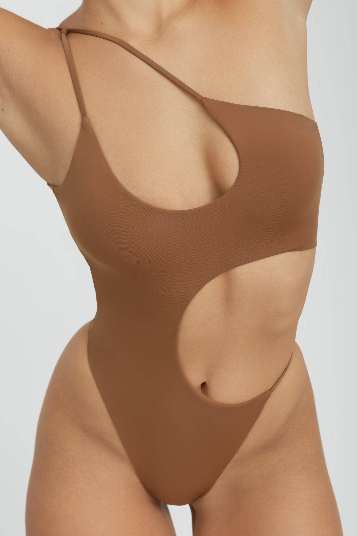 Riot Swim Blaise One Piece swimsuit in Brown Sugar, featuring a stylish cut and smooth fabric, displayed on a model.
