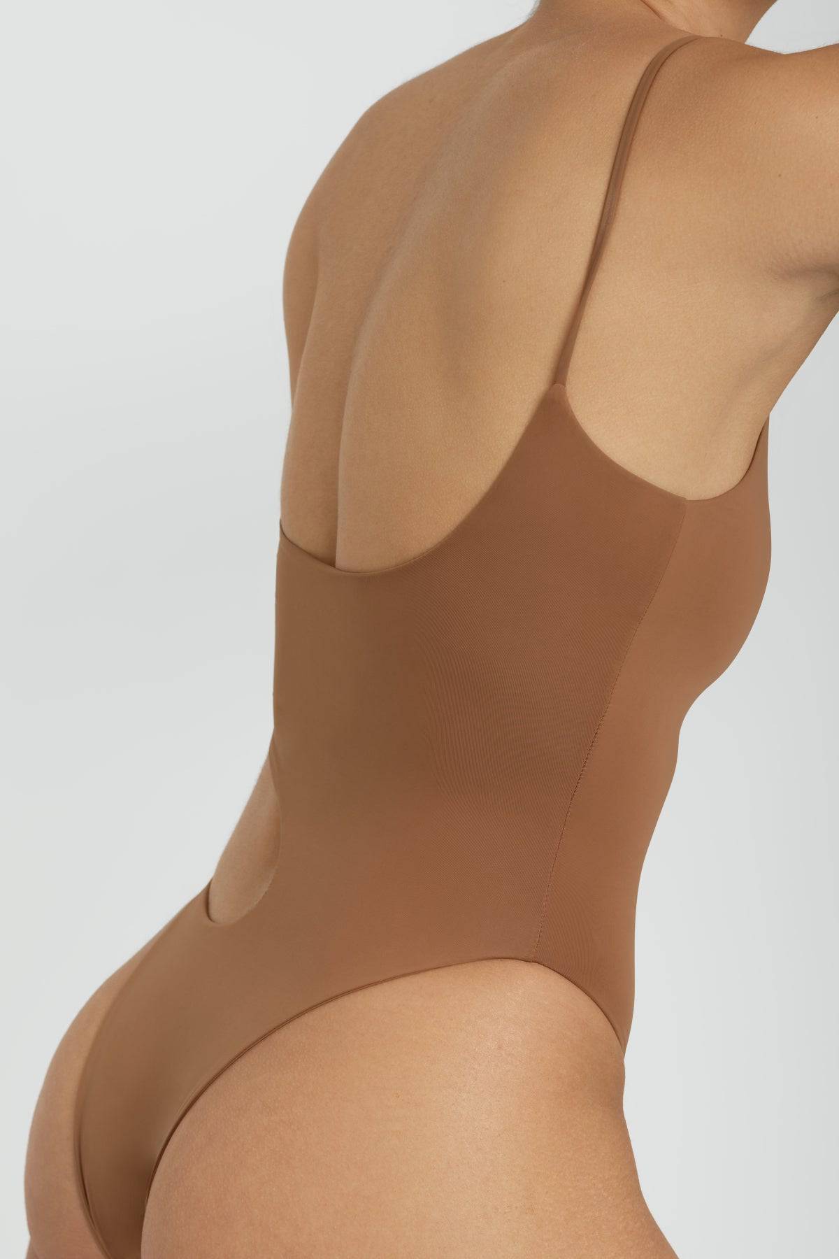 Riot Swim Blaise One Piece swimsuit in Brown Sugar color, featuring a sleek design and moderate coverage on a model.