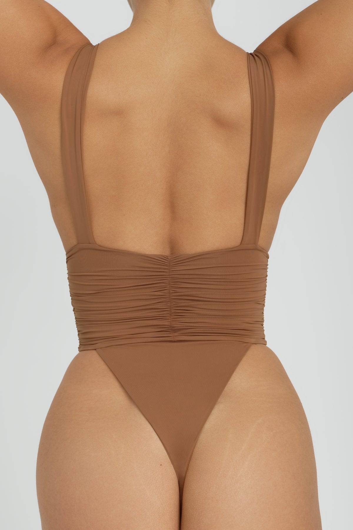 RIOT SWIM Echo One Piece Minimal swimsuit in Brown Sugar, featuring sleek design and minimal style, displayed on a model.