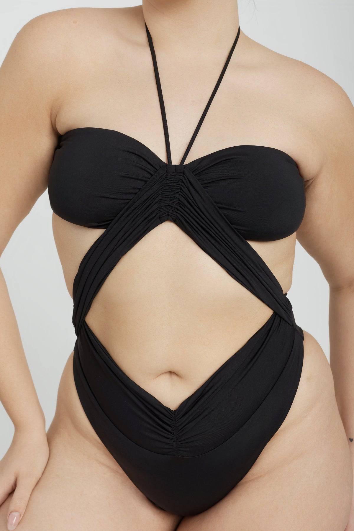 Black Phoenix One Piece swimsuit by RIOT SWIM featuring a sleek design and flattering fit, shown on a model.