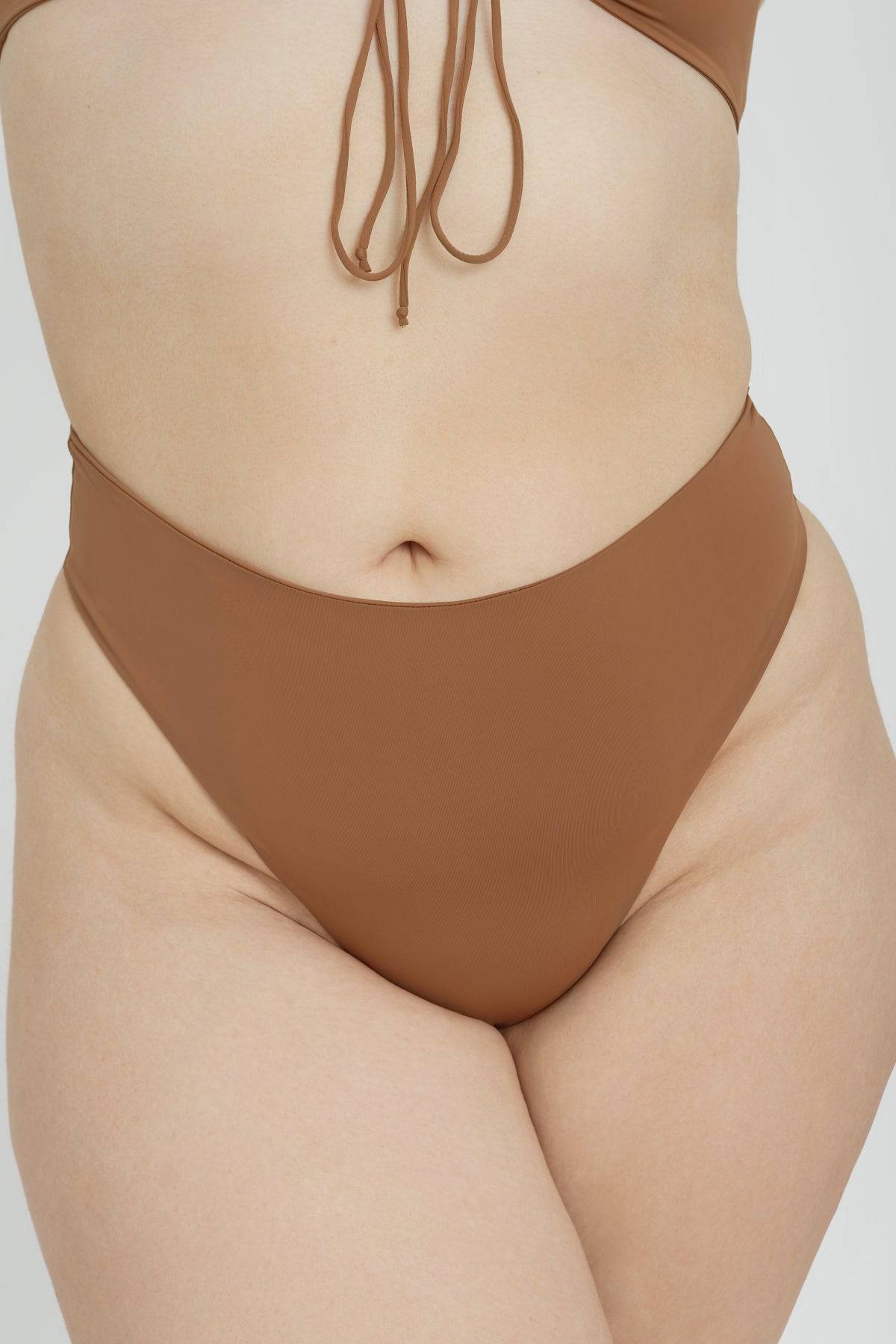 Riot Swim Kai high waist bottoms in brown sugar fabric, featuring a stylish fit and smooth texture for summer swimwear.