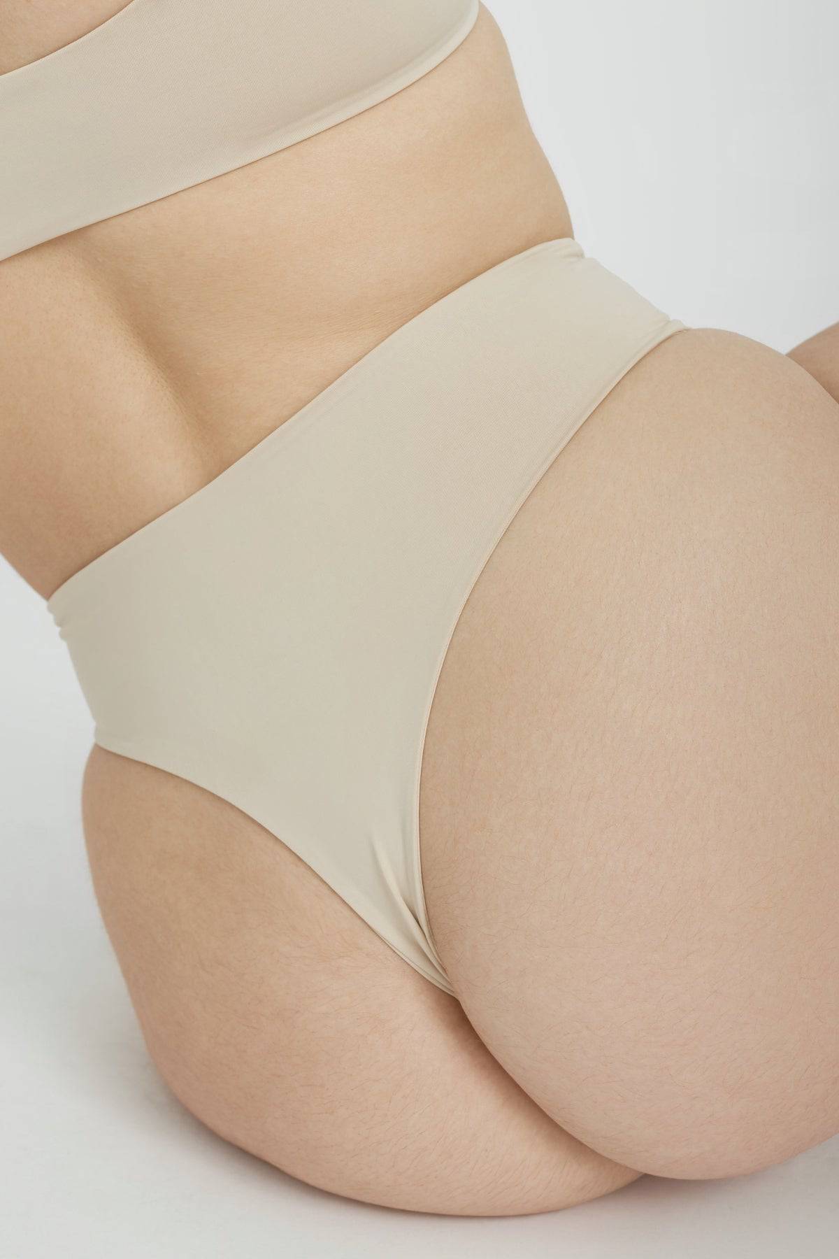 Riot Swim Kai High Waist Bottom in coconut color, featuring a sleek high-waist design and smooth fabric for a stylish beach look.