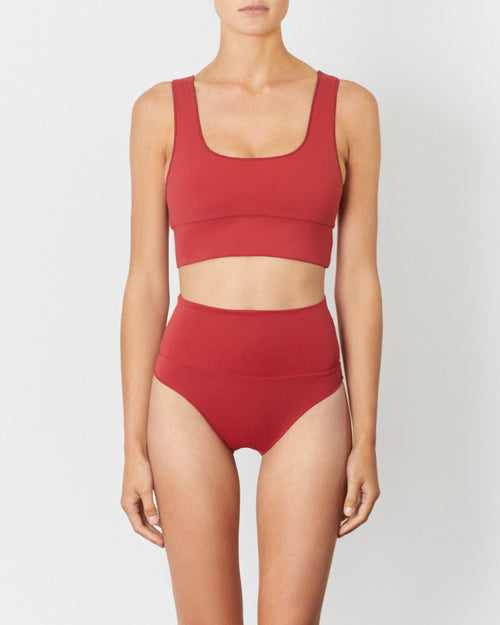 Studio image of model wearing the Contour High Waist Pant in Chilli Red.