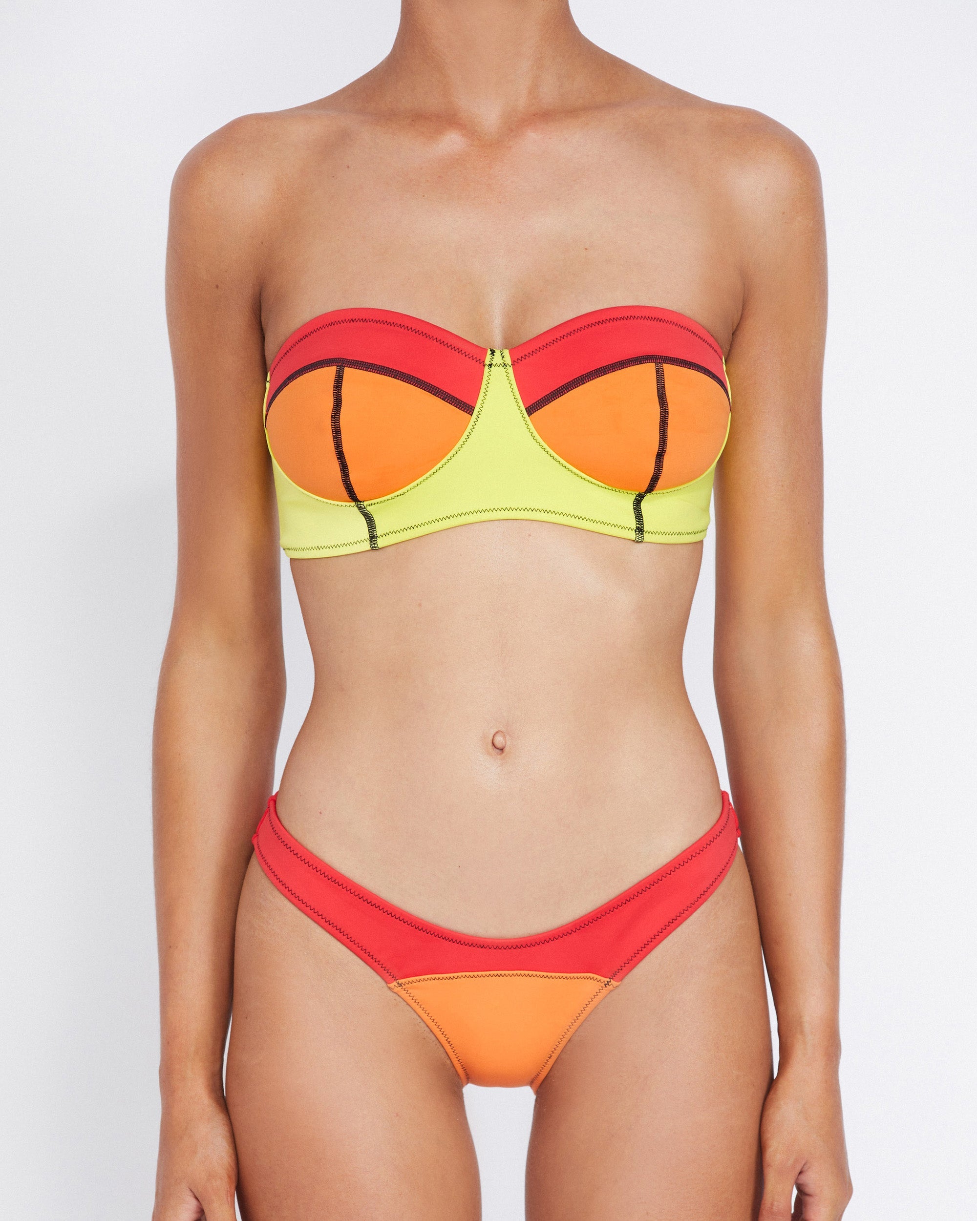 Studio image of model wearing the Neo Curve Pant in Pipeline, showcasing its sleek silhouette and vibrant colors. 