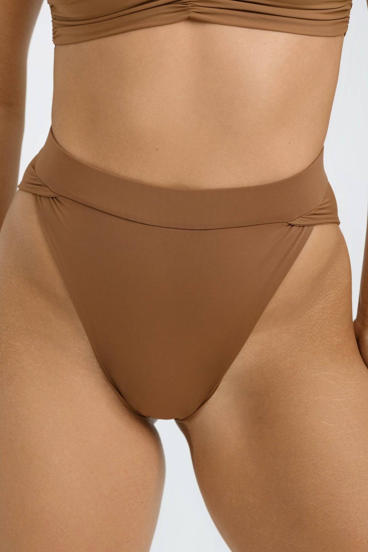 Light brown high-waisted bikini bottoms from Riot Swim's Vista Bottom collection, featuring a smooth fit and stylish design.