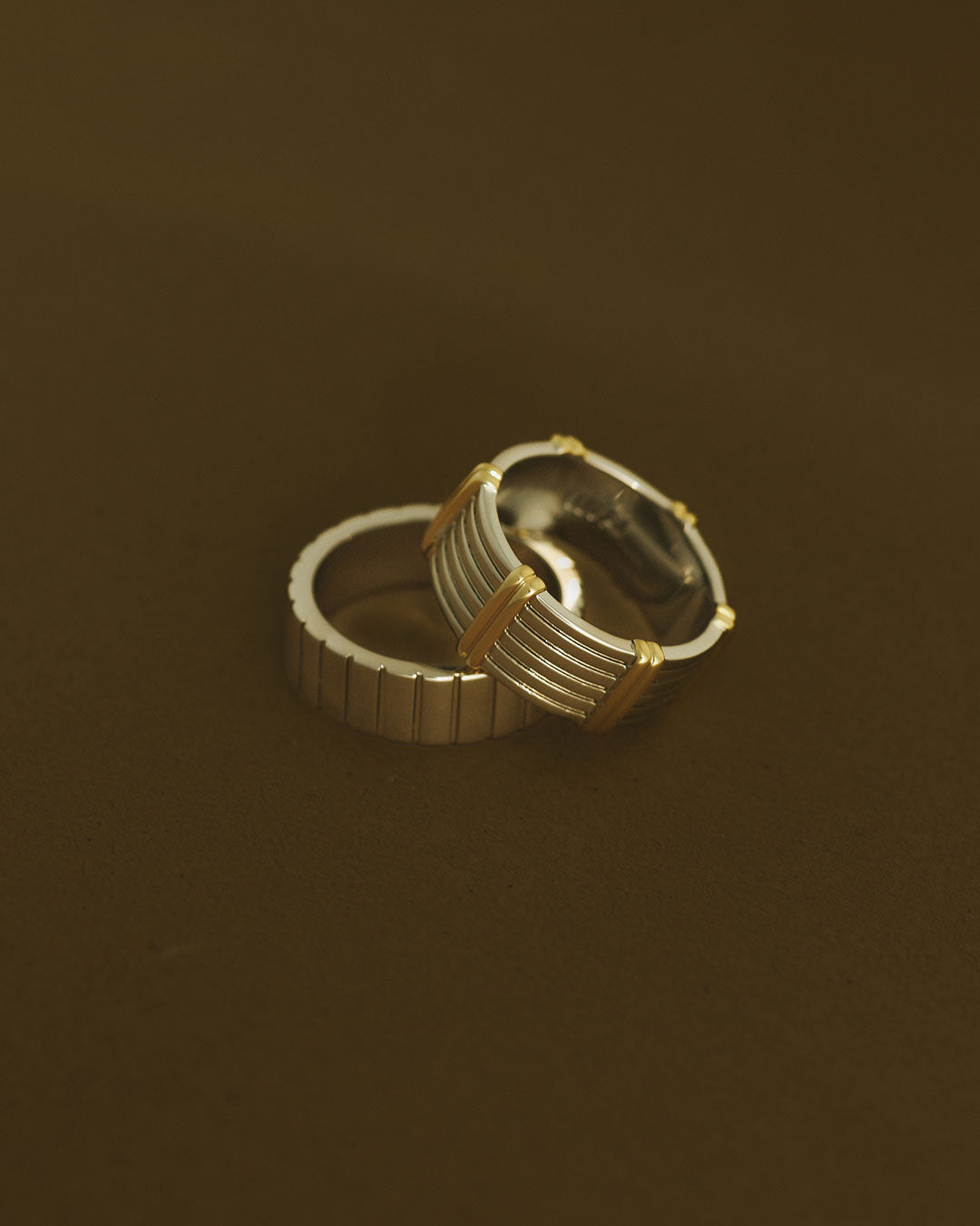 The Luv Aj Luna Bezel Ring Set in Silver on a brown background