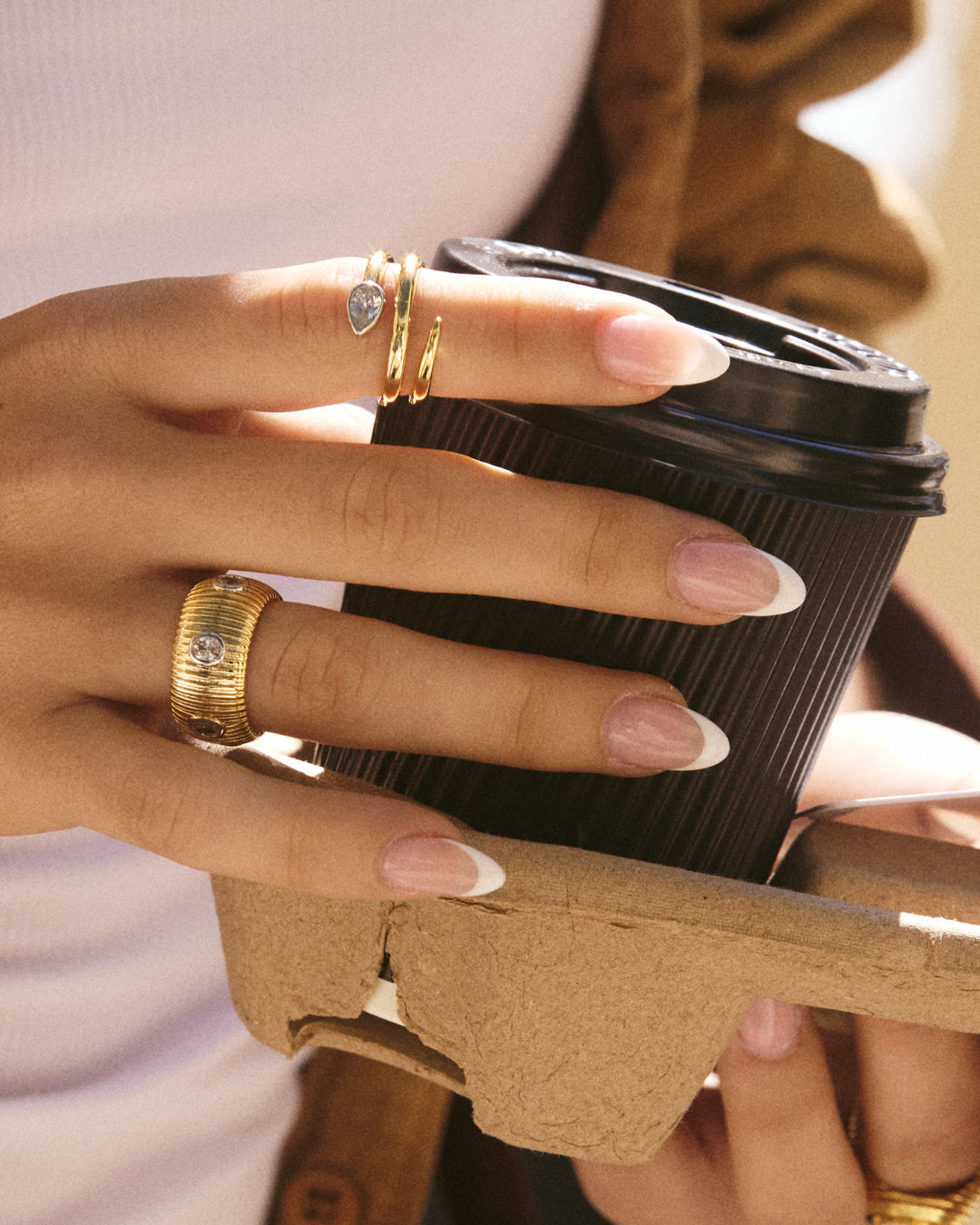 The Luv Aj Marais Coil Ring in Gold on Model's Index Finger