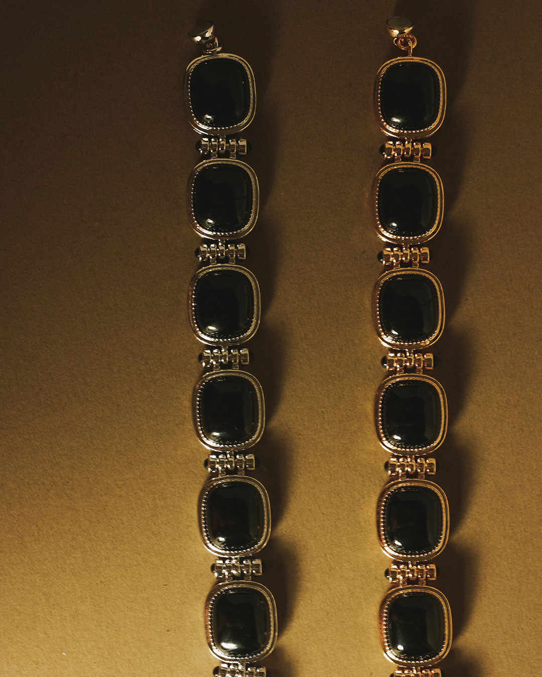 The Luv Aj Midnight Beaded Bracelet in Gold and Silver on Golden background