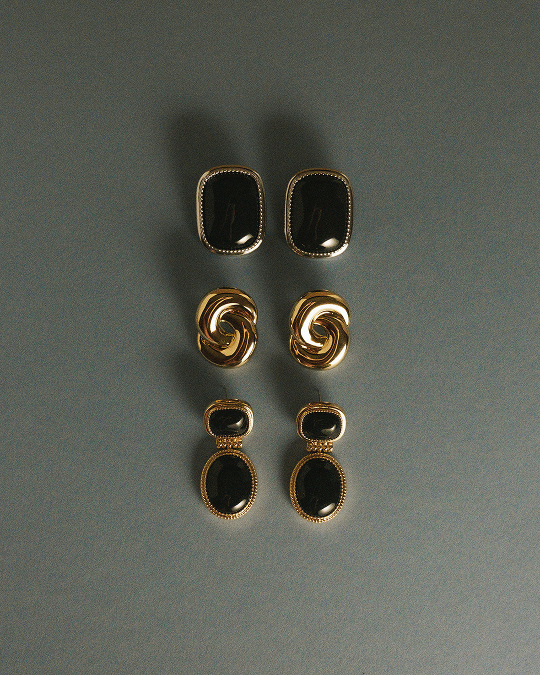 The Luv Aj Midnight Mesa Drop Studs in Gold on bottom row