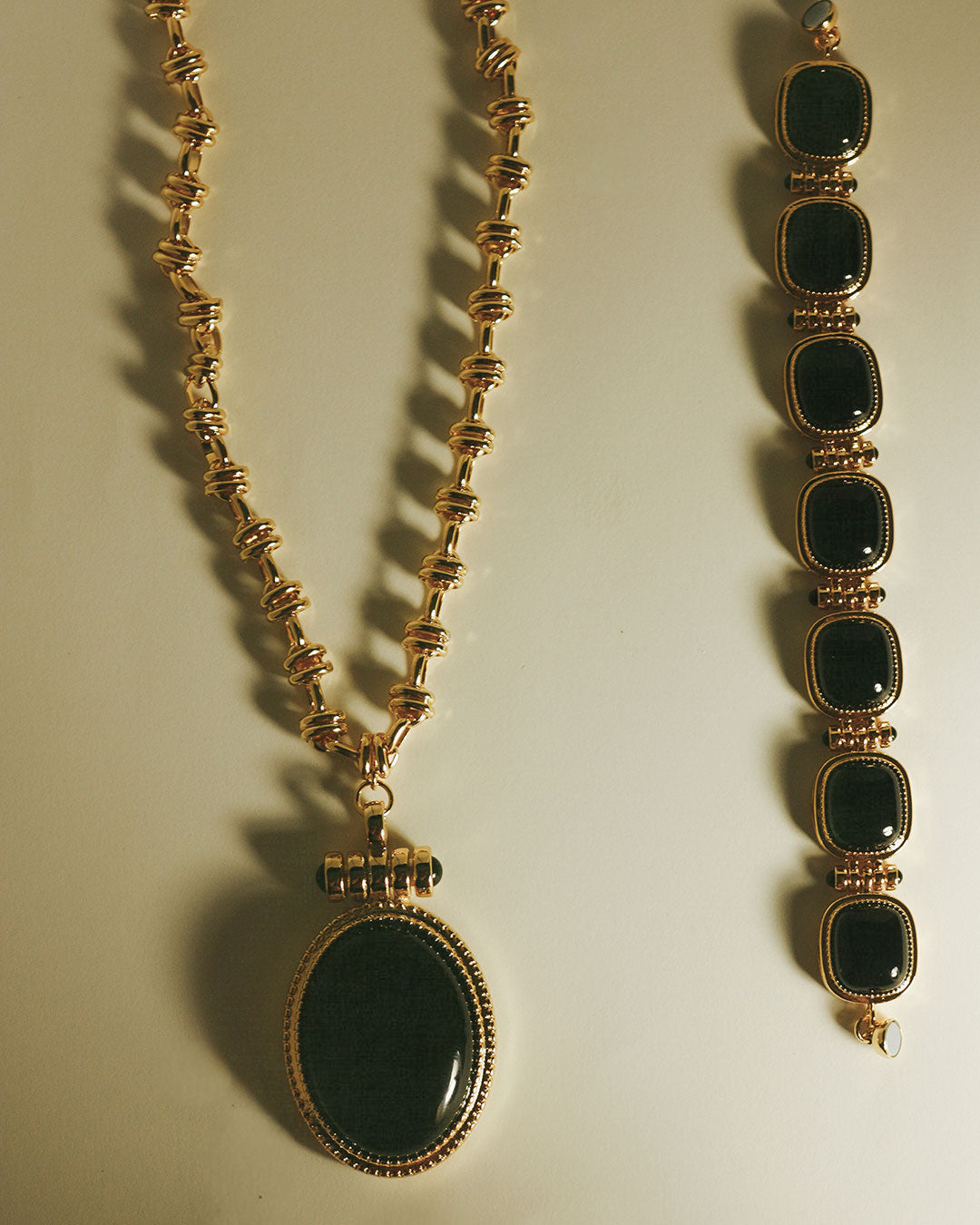 The Luv Aj Midnight Mesa Pendant Necklace in Gold on flat background