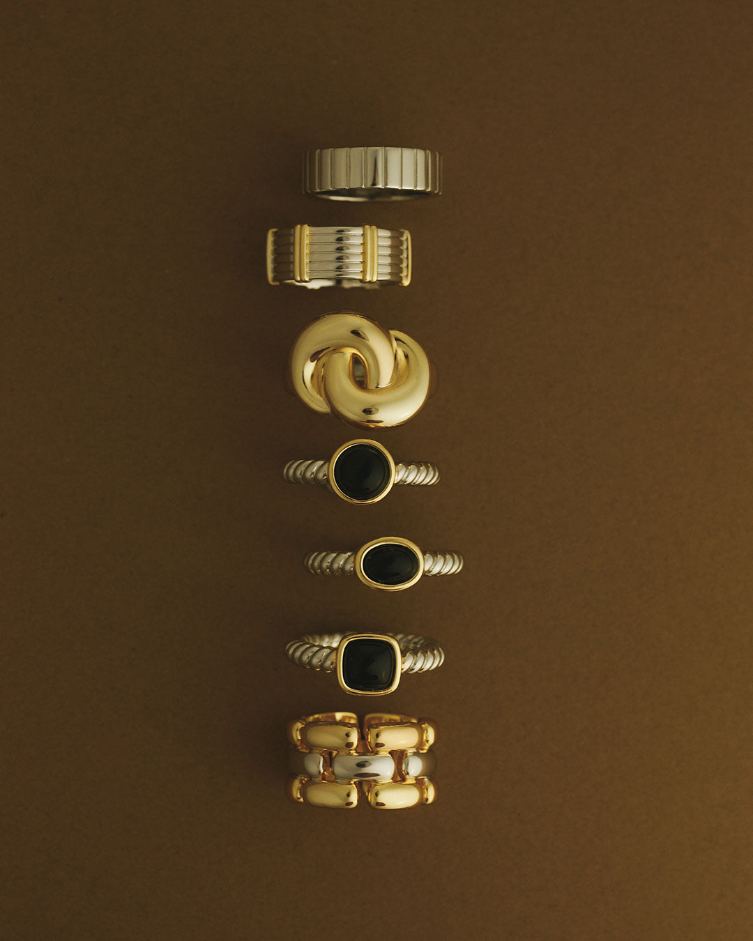The Luv Aj Midnight Mesa Collection Rings on brown background