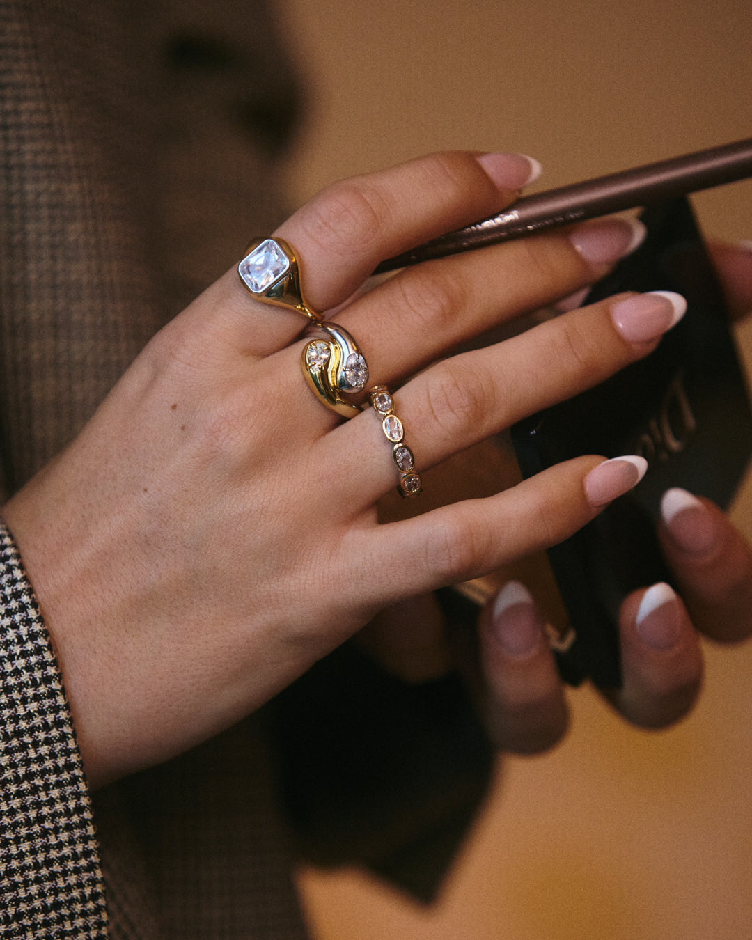 The Luv Aj Palais Statement Ring in gold on model's index finger