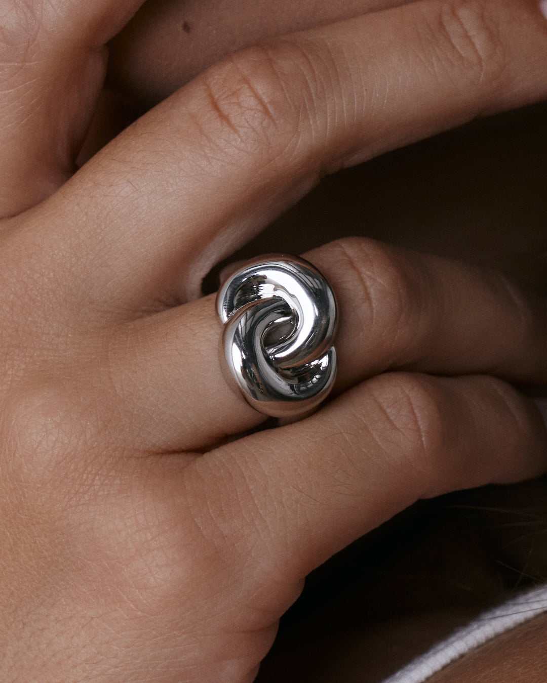 The Luv Aj Solstice Knot Ring in Silver on Model's hand