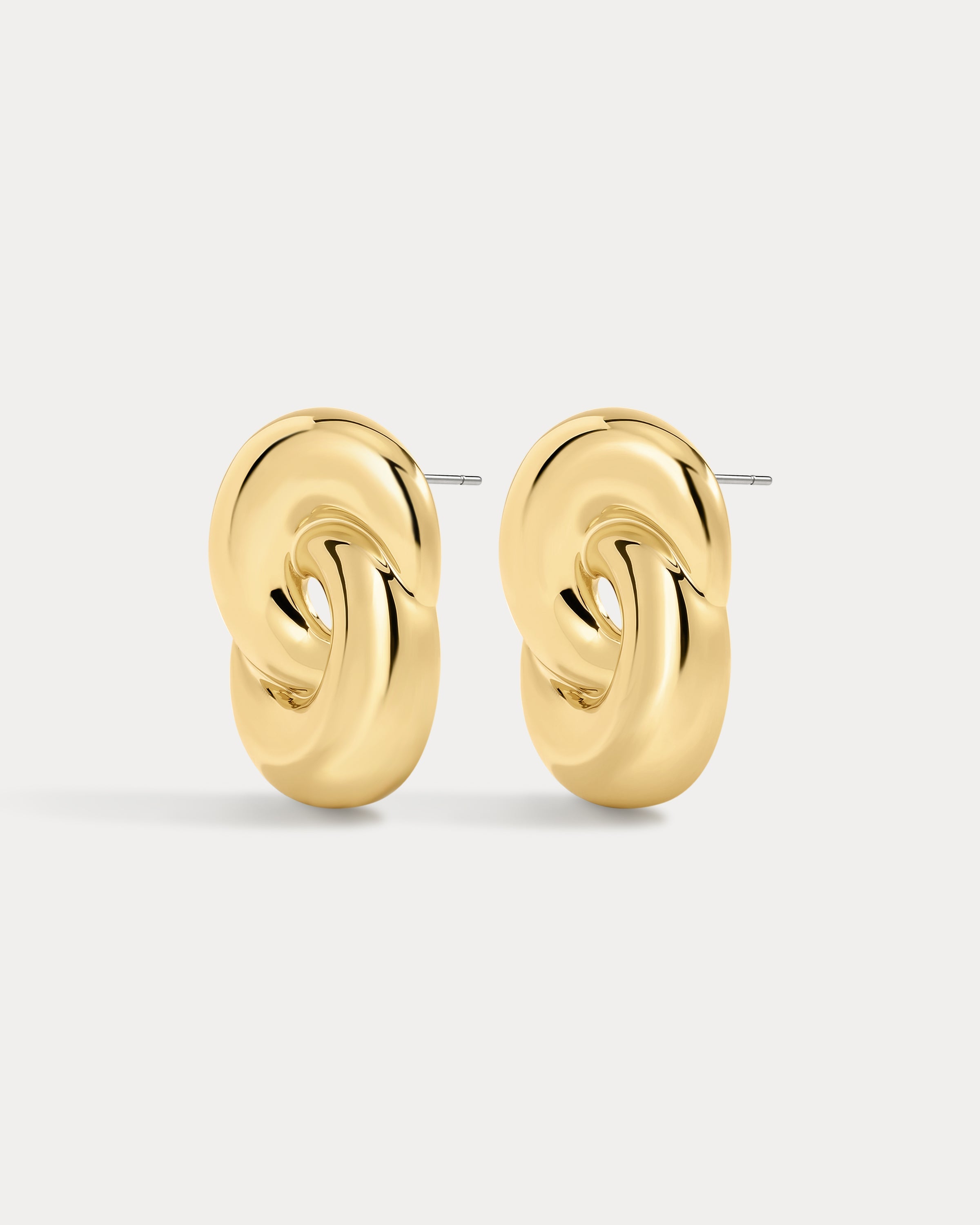 The Luv Aj Solstice Knot Studs in Gold on White Background