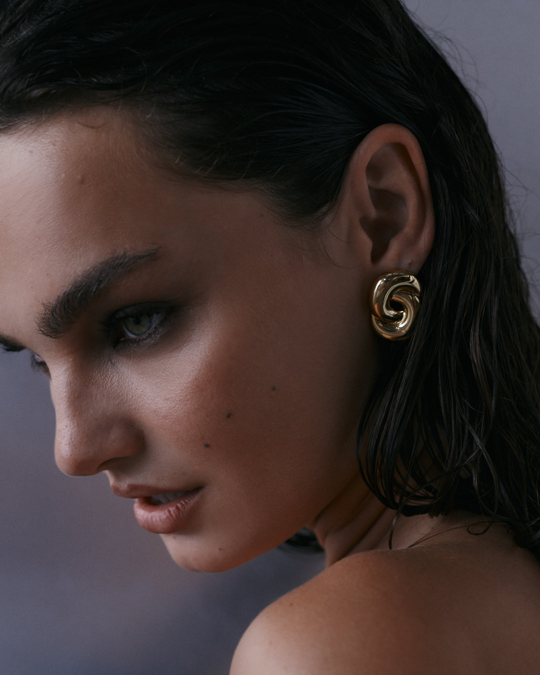 The Luv Aj Solstice Knot Studs in Gold on Model