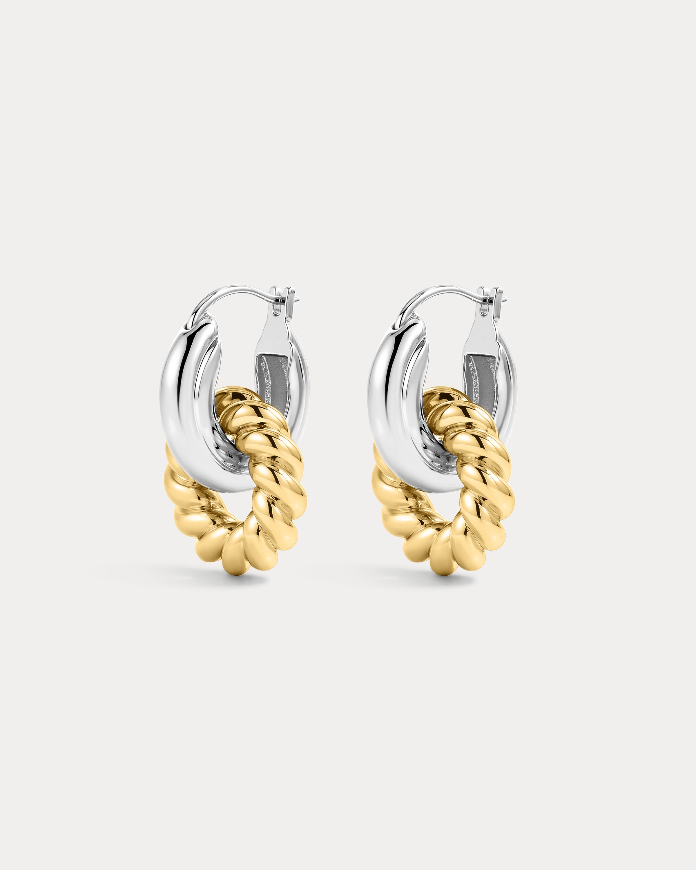 The Luv Aj Two-Tone Rope Interlock Hoops in silver on white background