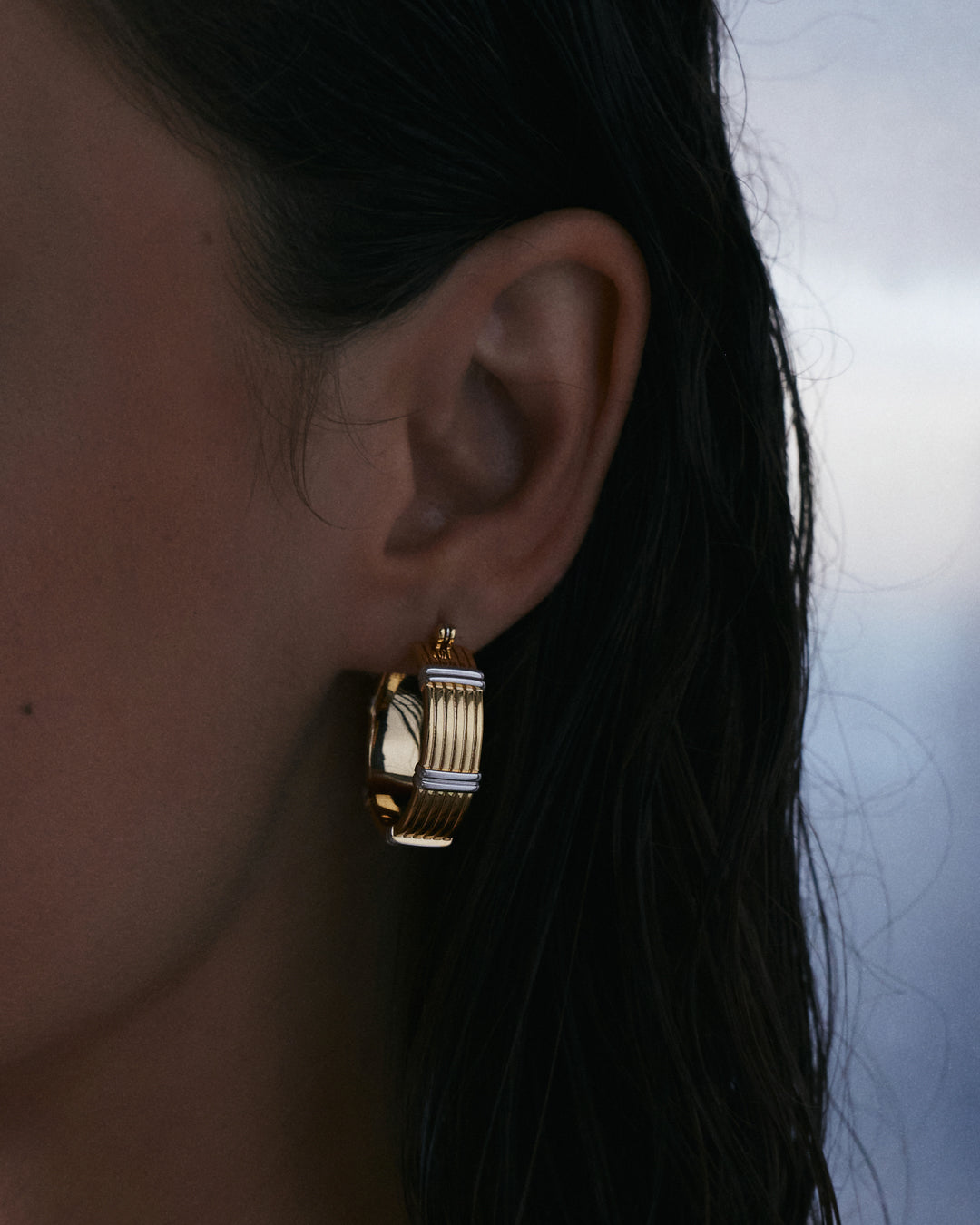 The Luv Aj Two Tone Sierra Bar Hoops in gold on model