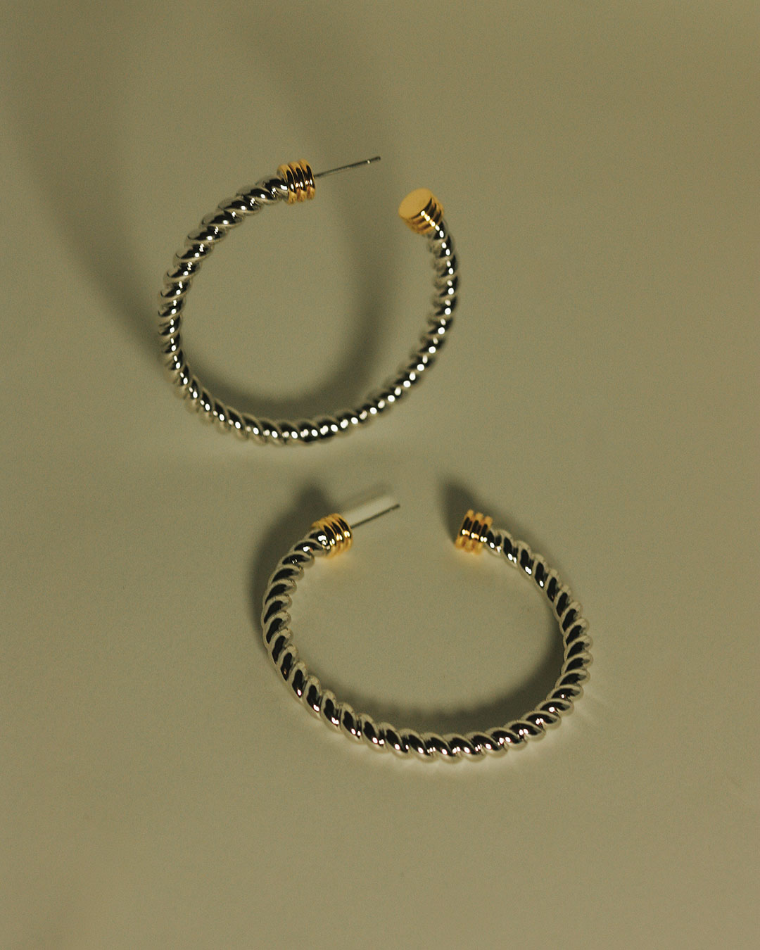 Flat Lay Photo of the Luv Aj XL Sierra Rope Hoops in Silver