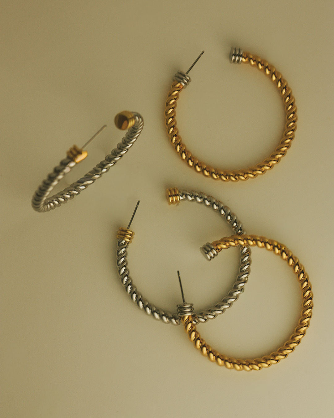 Flat lay photo of the Luv Aj XL Sierra Rope Hoops in Gold and Silver