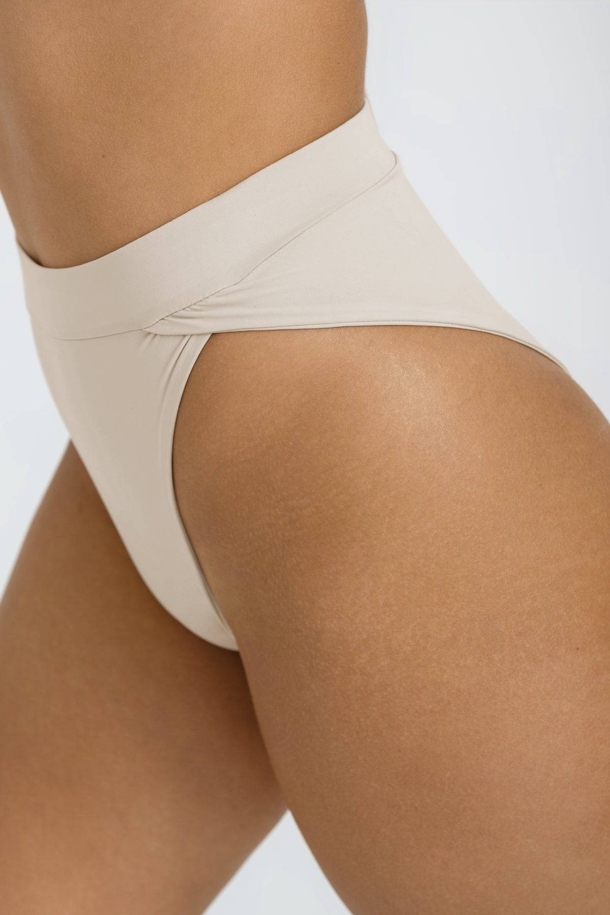 Riot Swim Vista coconut high-waisted bikini bottoms with a smooth fit and tropical coconut print on sleek swimwear fabric.