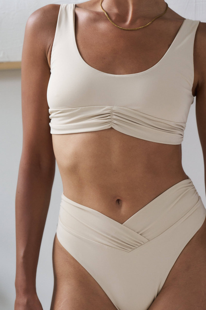 Close-up of RIOT SWIM Pico Top in coconut color, showcasing the stylish design and fabric details of the bikini top.