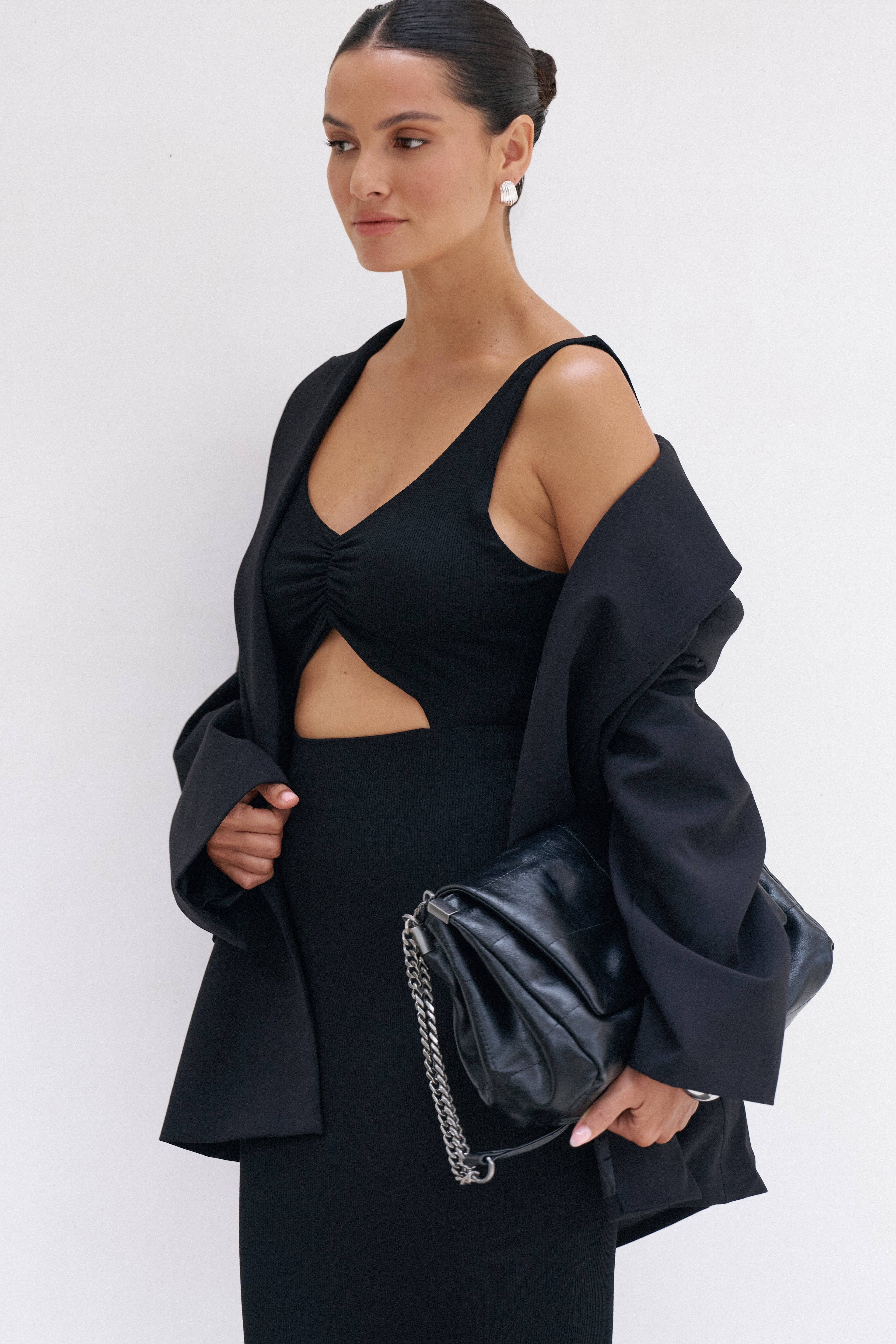 Black Reily Maxi Dress by Riot Lounge, flowing fabric and elegant design, shown on a model.
