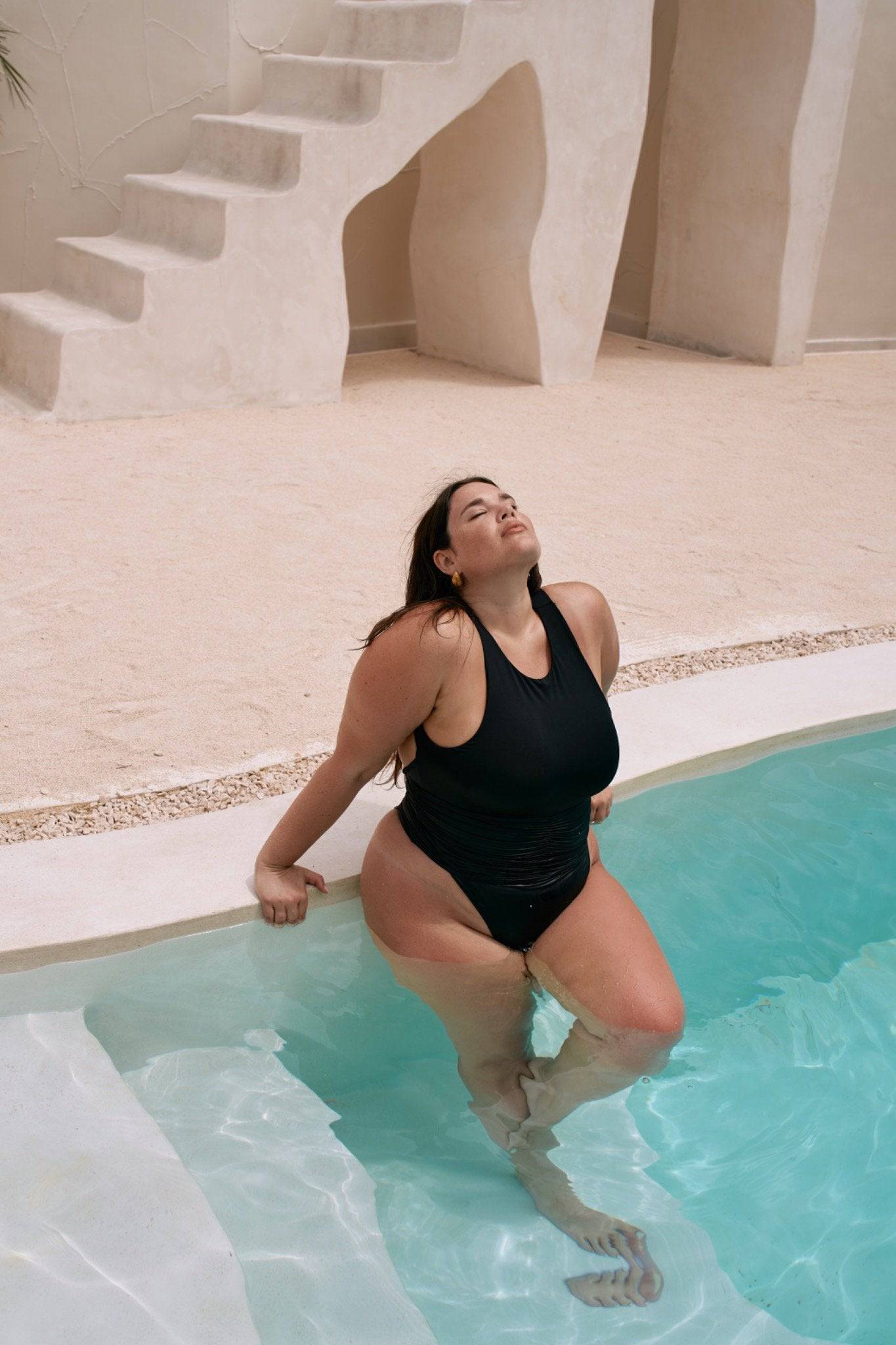 Black Riot Swim Jace One Piece swimsuit with a sleek, minimal design, displayed on a model emphasizing its stylish fit.