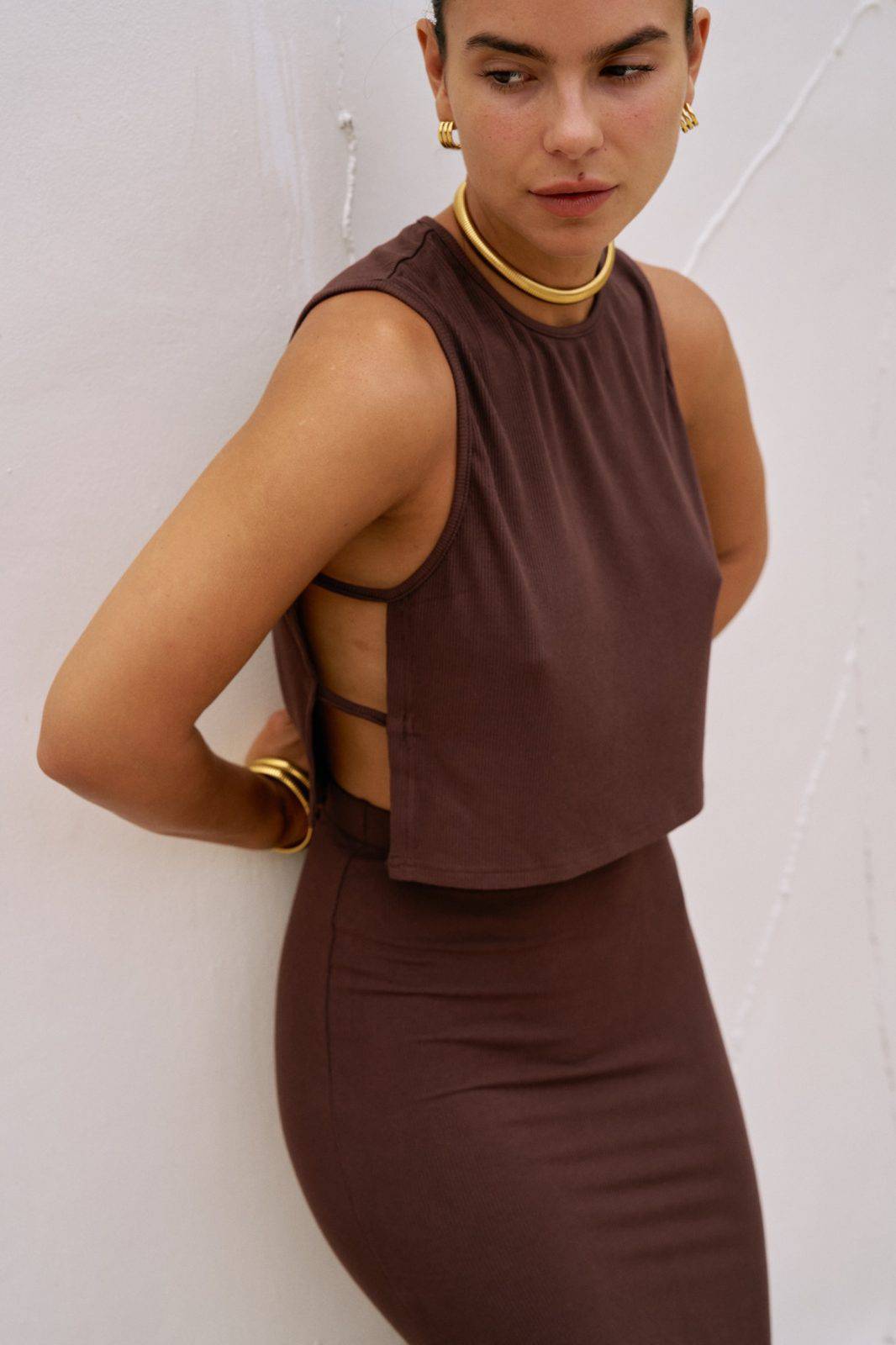 Riot Lounge Simi Side Strap Tank in chocolate, paired with a maxi skirt, showcasing stylish sleeveless top with side strap details.